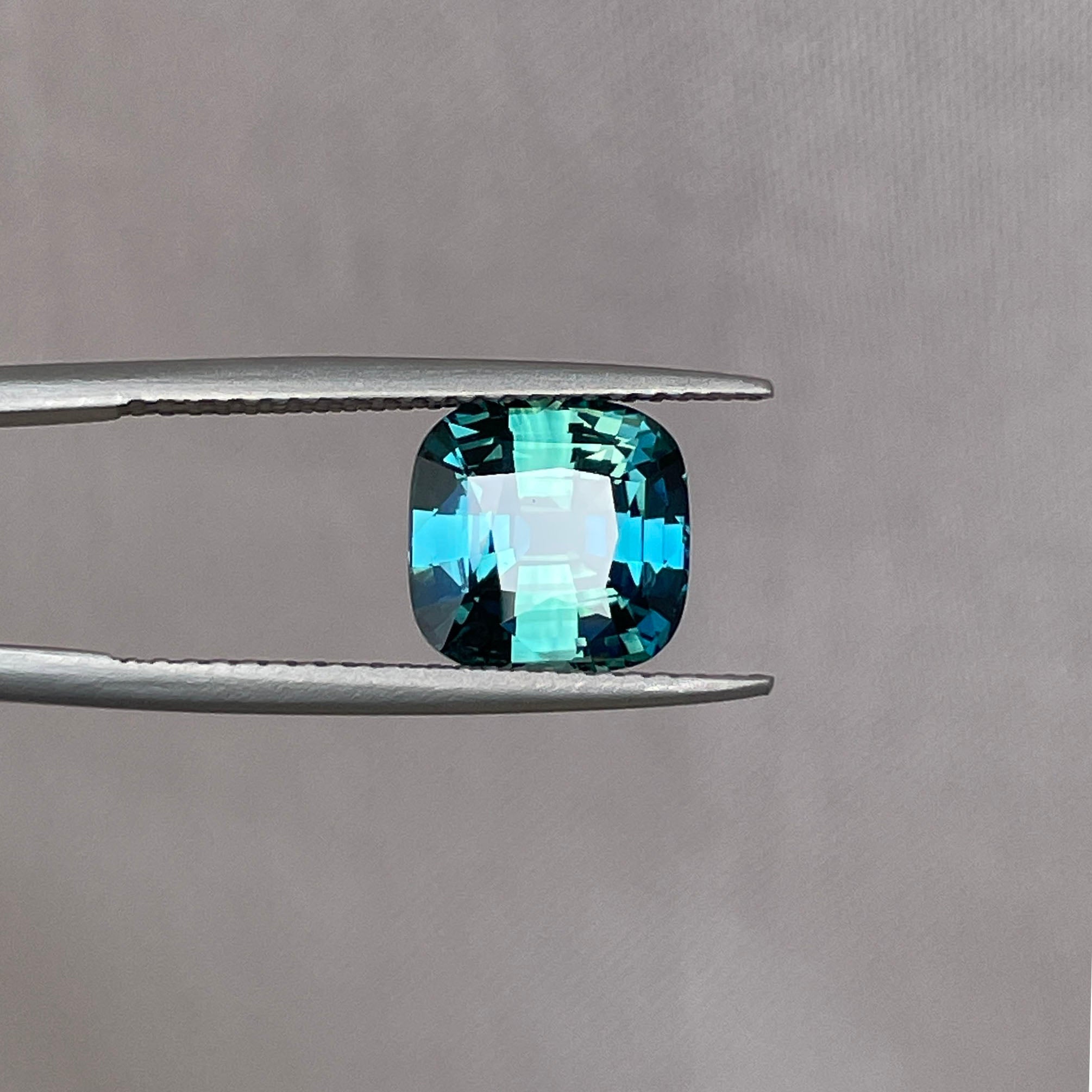 Teal sapphires from Madagascar arranged on natural stone