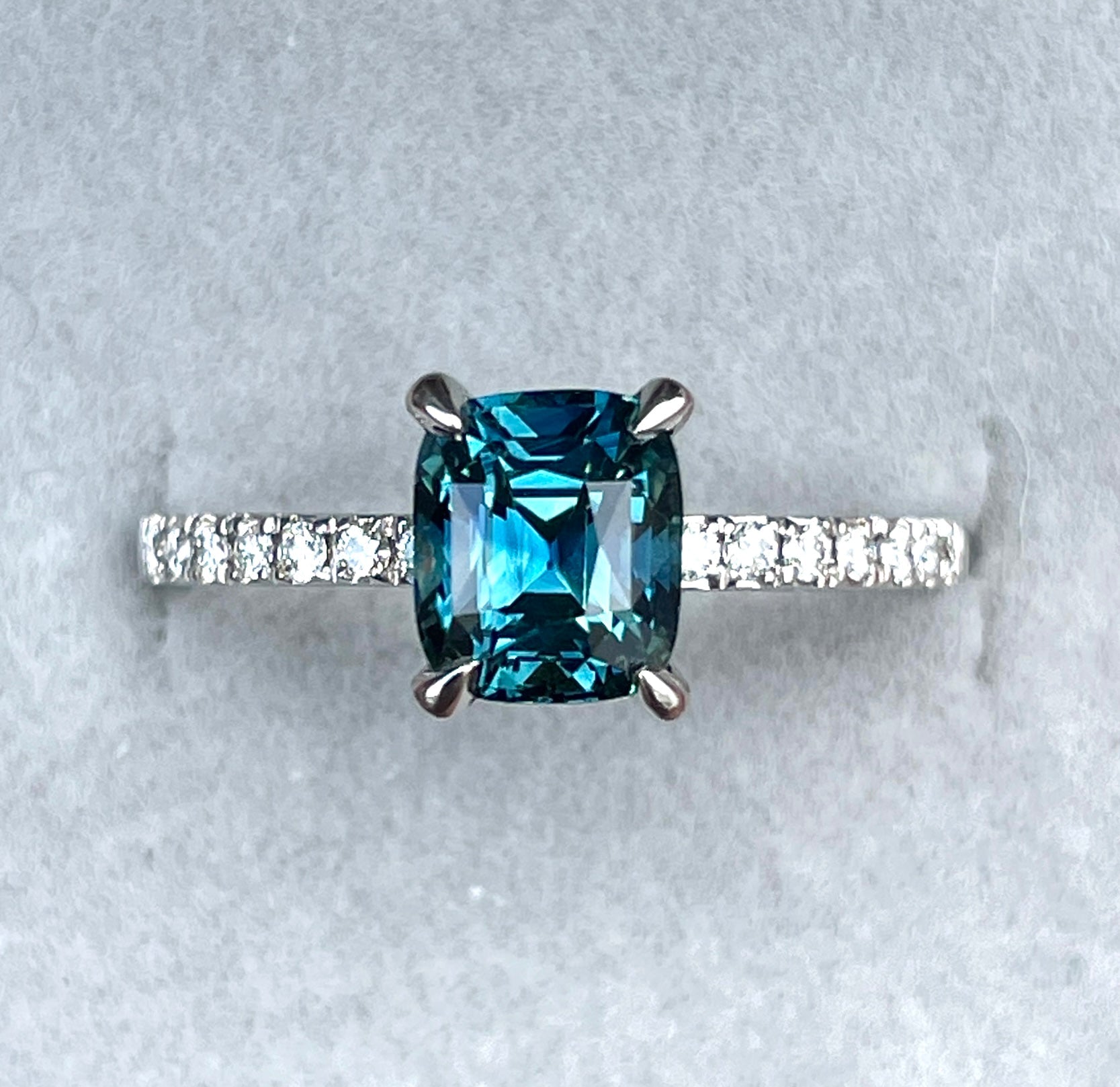 Blue green sapphire engagement ring with diamonds setting with white gold band