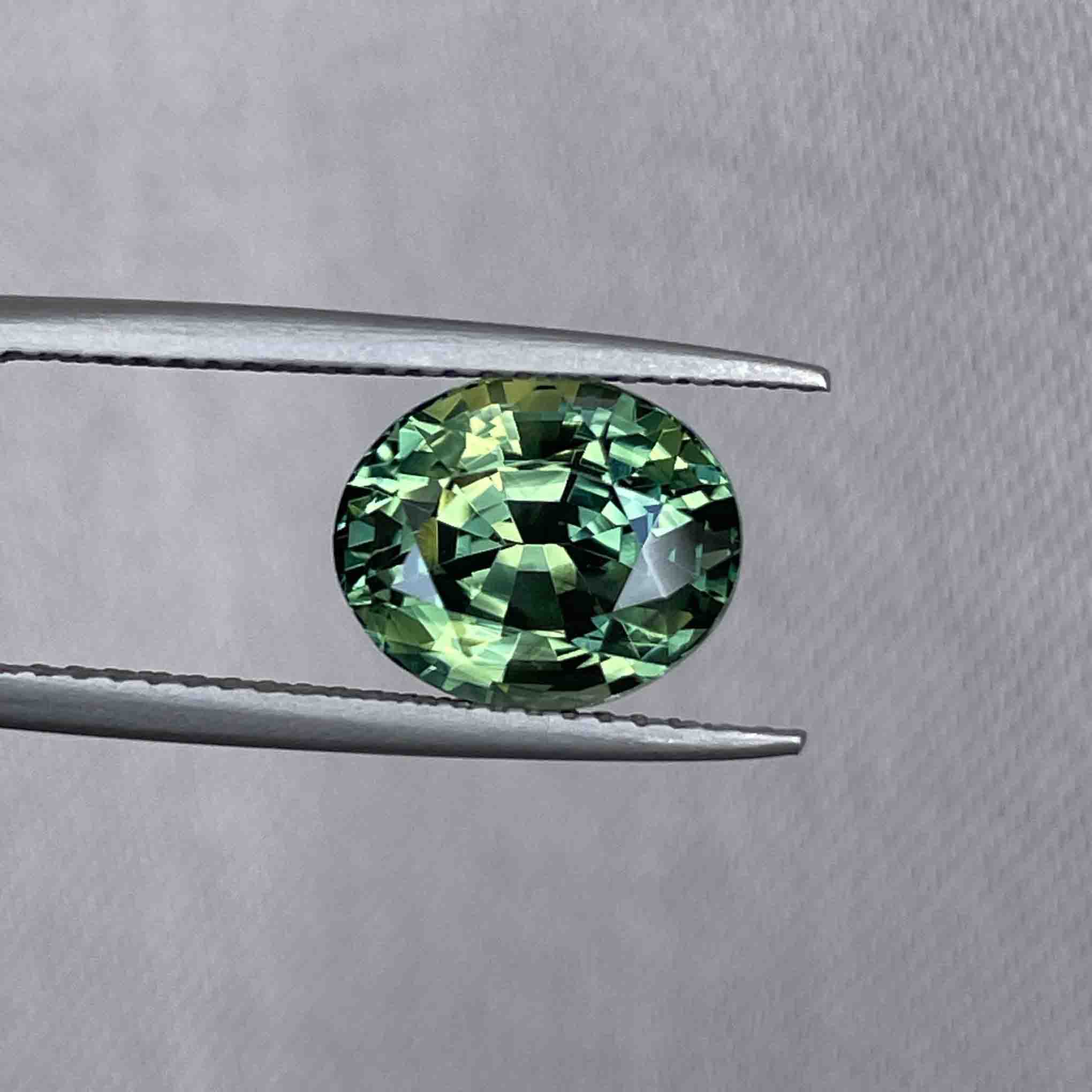 Close-up photo of bi-color sapphire with distinct yellow and green zoning