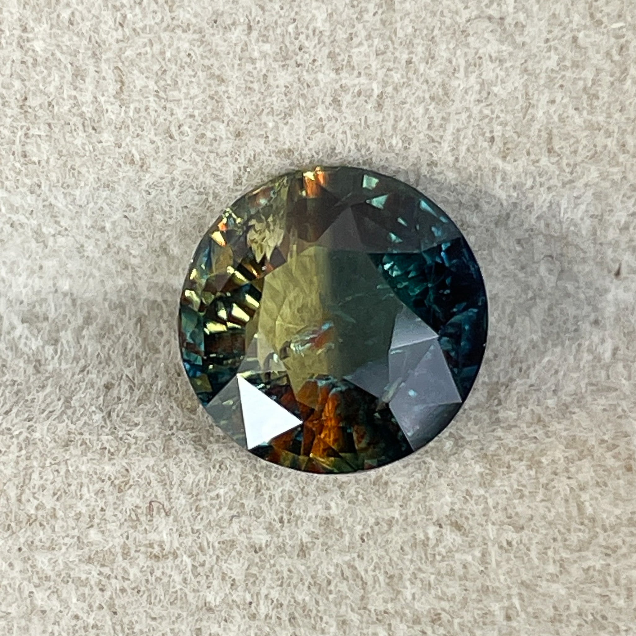 Teal natural bi-color sapphire, 3.70 carats, round cut loose gemstone from NASHGEMS, ideal for custom jewelry or engagement rings.