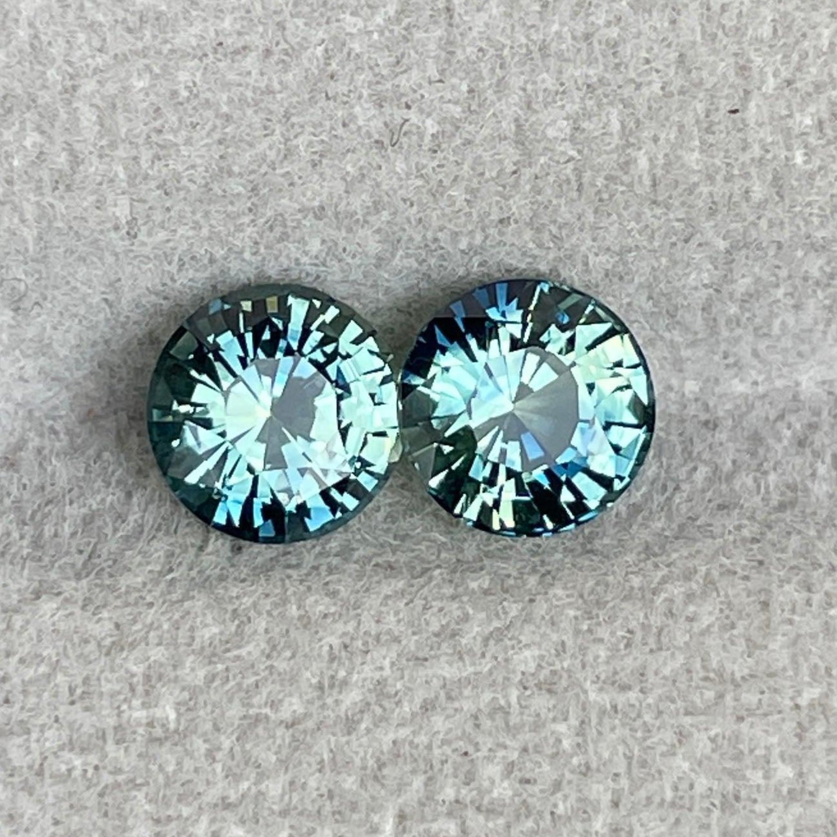 Pair of blue-green teal sapphire round cut gemstones, 2.30 ct., by NASHGEMS, ideal for anniversary, engagement, or Mother's Day gifts.