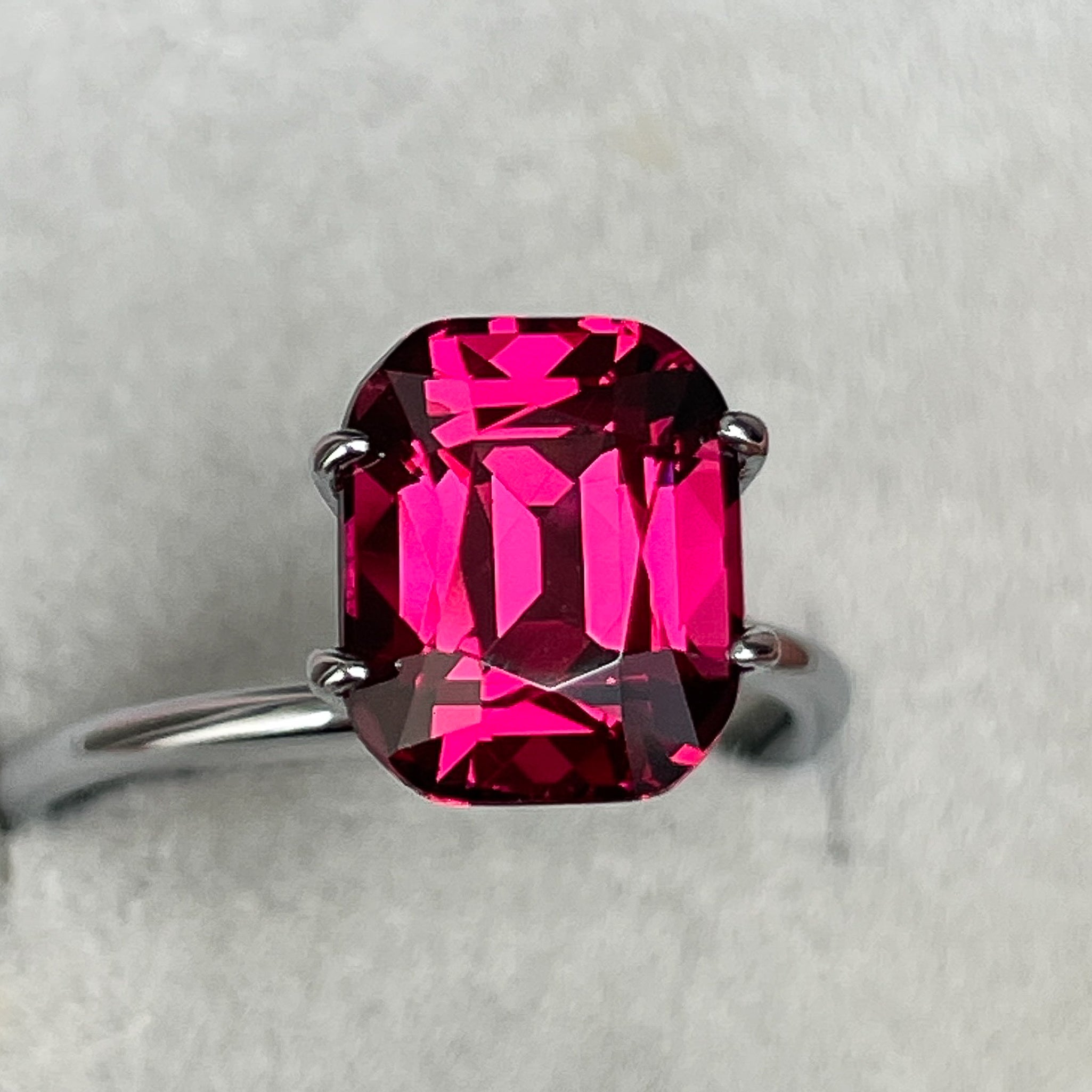 Natural Rhodolite Garnet 4.53 Ct cushion cut gemstone in raspberry red, VVS clarity, from NASHGEMS for engagement rings.