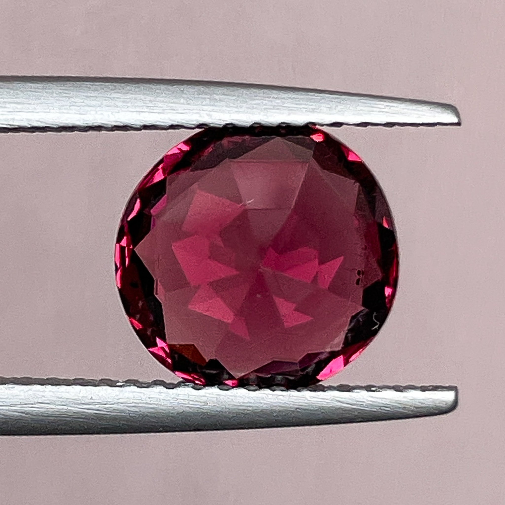 Natural Rhodolite Garnet 3.13 Ct round cut gemstone with raspberry red color, VVS clarity, suitable for engagement rings.