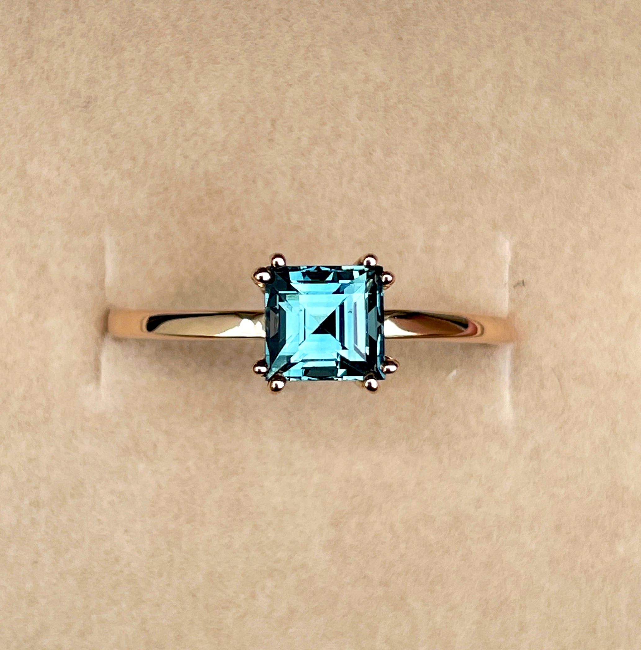elegant ring features a 1.00 crt  Natural Teal Sapphire surrounded by sparkling natural white sapphire set in a solid 18k Rose Gold ring setting. - NASHGEMS