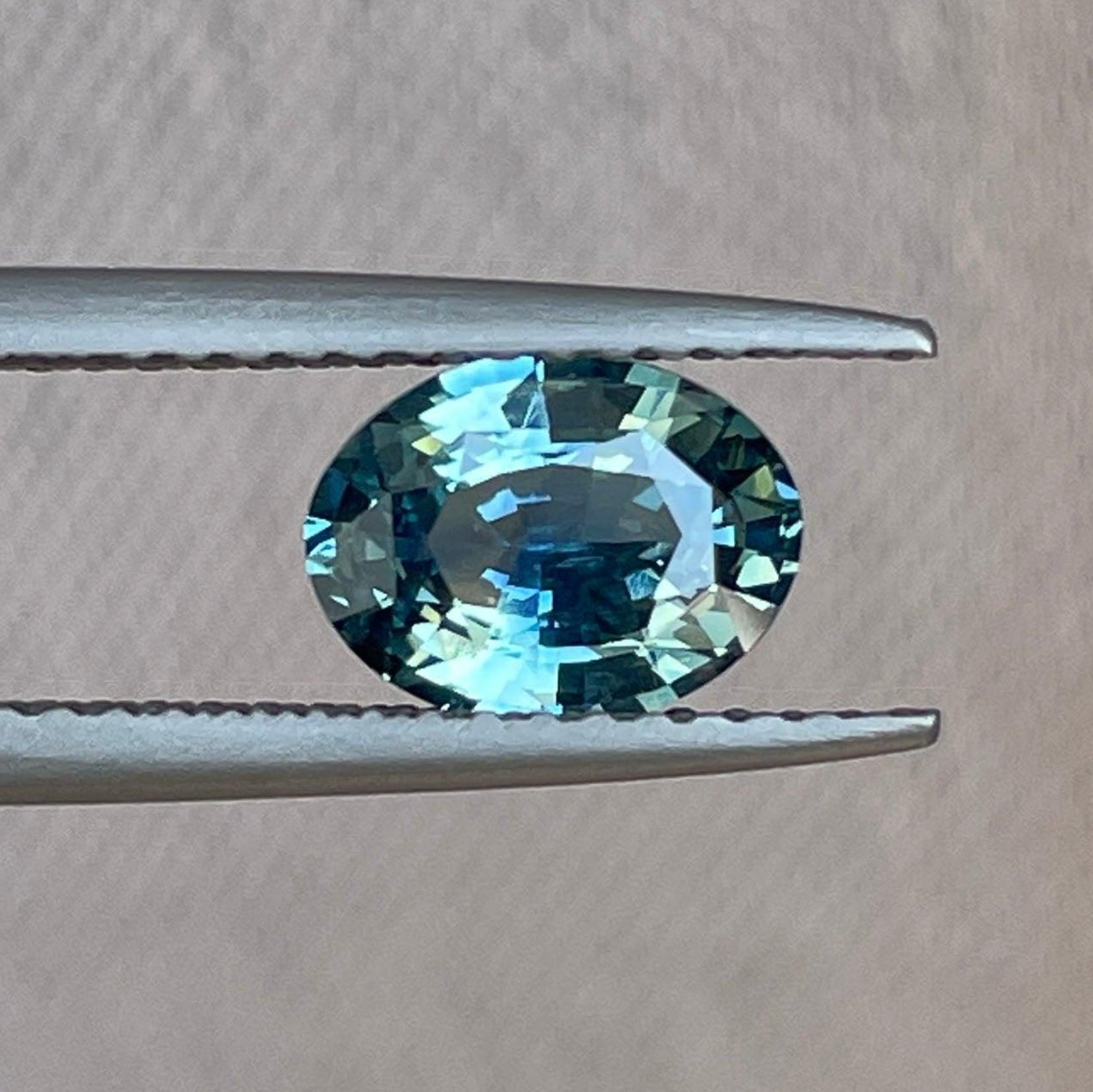 Blue-green sapphire oval-shaped loose gemstone, 1.16 carats, ideal for jewelry making and custom designs by NASHGEMS.