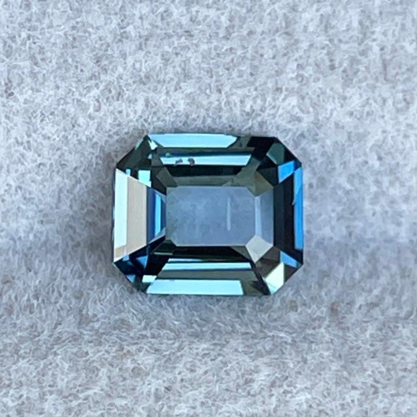 Teal sapphire anniversary ring with blue-green sapphires, 0.86 carats, from NASHGEMS, showcasing a unique engagement ring design.