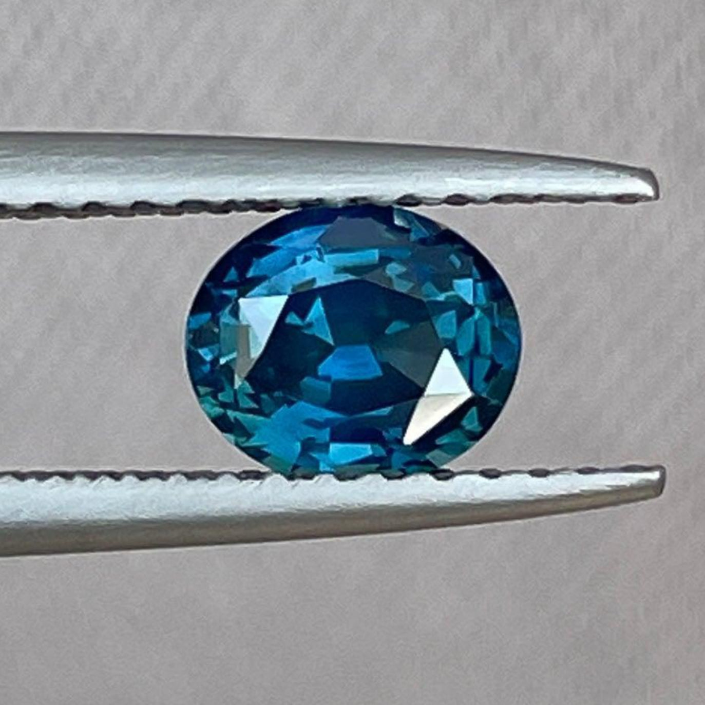 Natural 1.03 ct teal sapphire oval gemstone from NASHGEMS, perfect for engagement rings, custom jewelry, or necklaces.