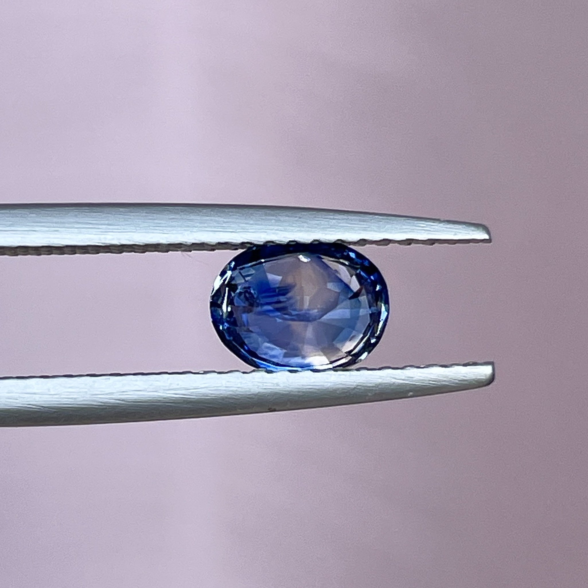 Oval-shaped natural Ceylon blue sapphire loose gemstone, 1.08 Ct, heat treated, ideal for engagement rings or custom jewelry.