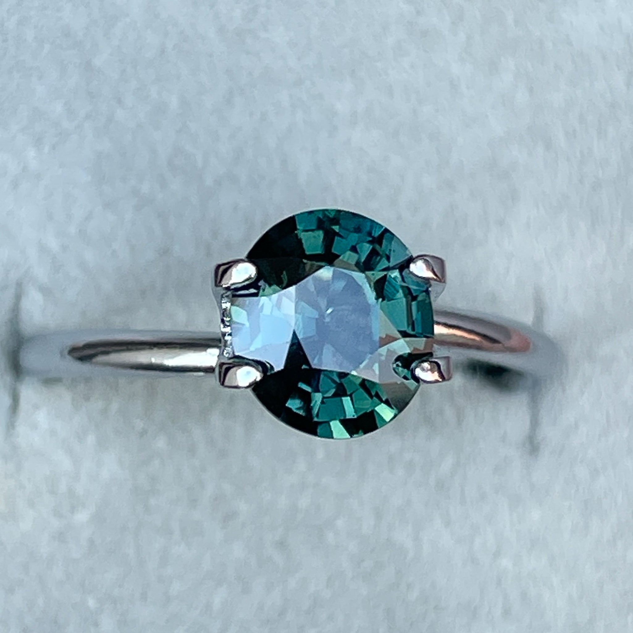 Natural forest green sapphire, 1.56 Ct oval cut loose teal gemstone from NASHGEMS for engagement or custom jewelry.
