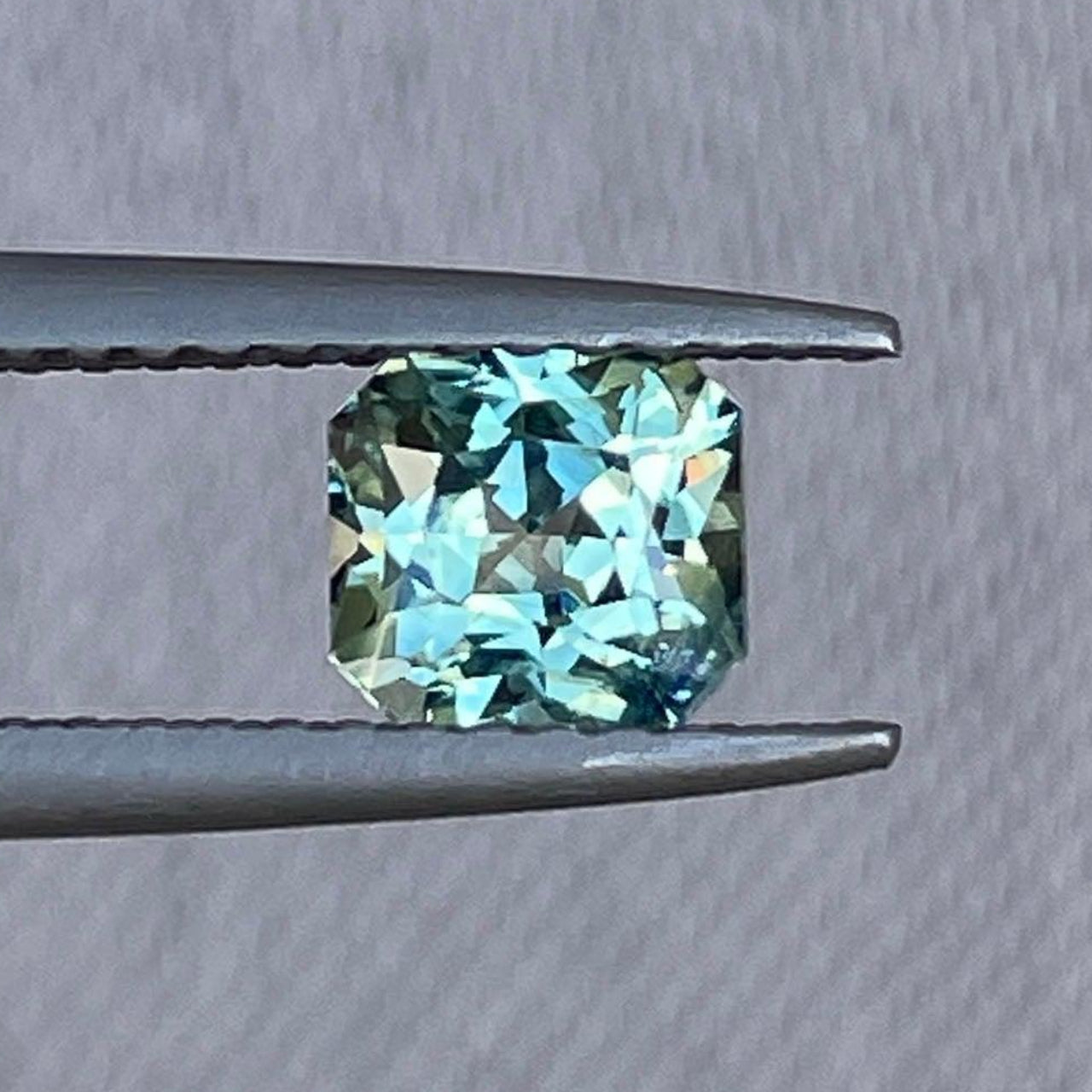 Natural teal sapphire ring featuring a 0.88 Ct parti sapphire, showcasing a bespoke design with a stunning teal gemstone.