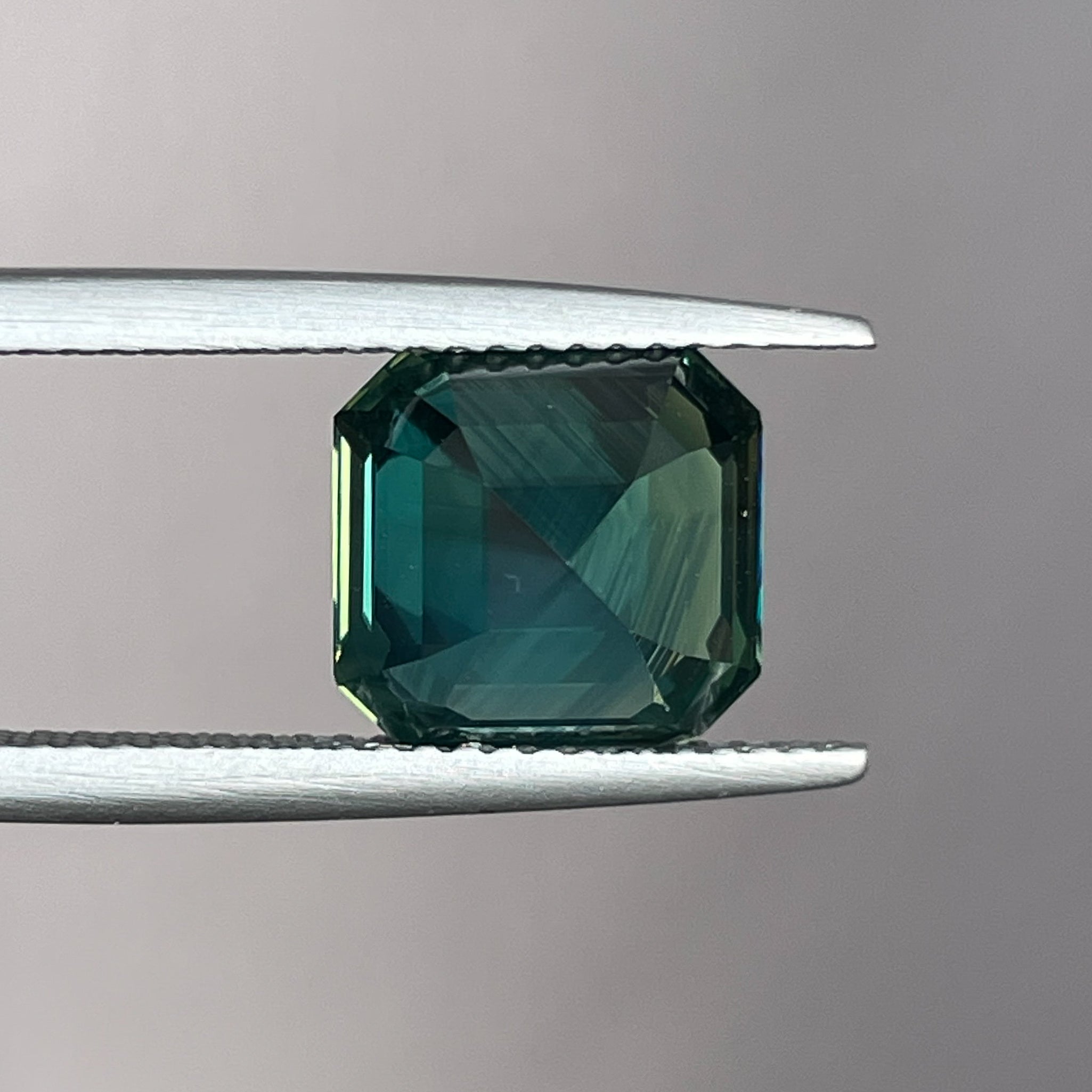 Natural green sapphire 5.08 ct Asscher emerald cut by NASHGEMS, showcasing a vibrant teal gemstone for engagement or custom jewelry.