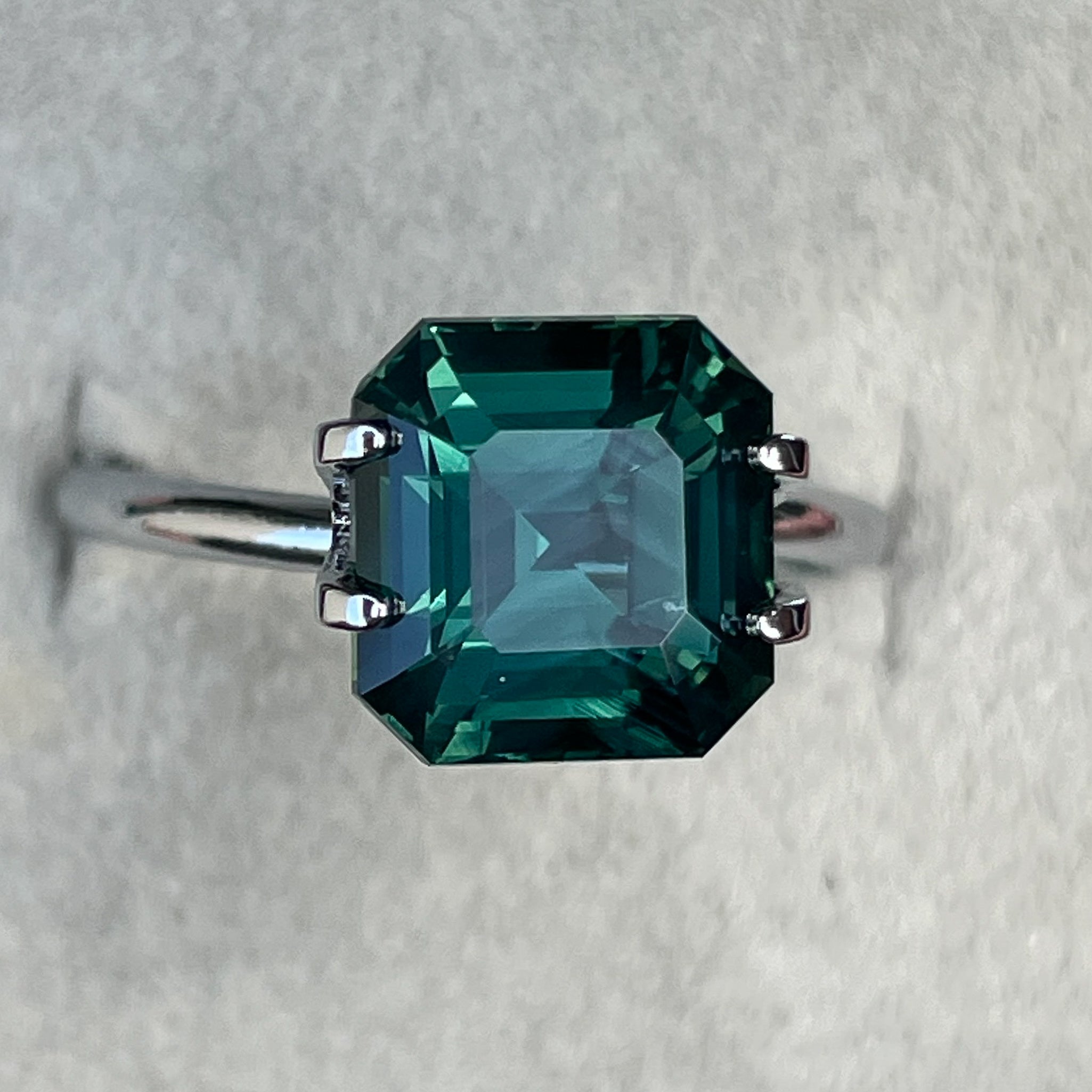 Natural green sapphire 5.08 ct Asscher emerald cut, teal loose gemstone from NASHGEMS, ideal for engagement or custom jewelry.
