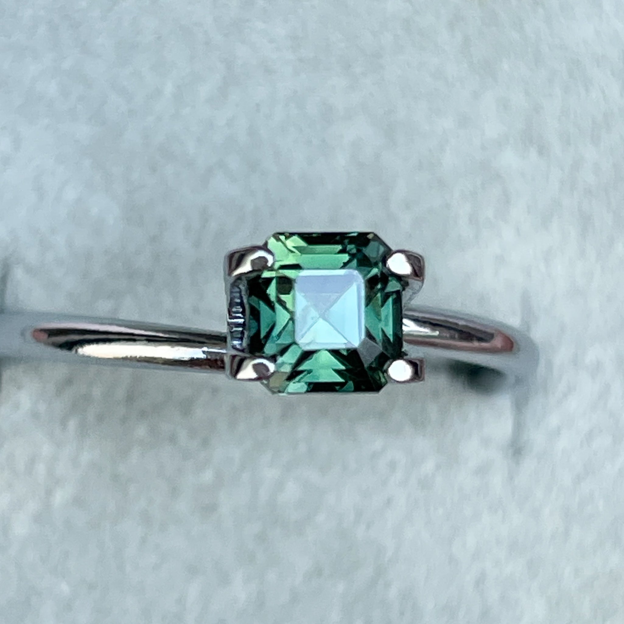 Natural forest green sapphire, 1.09 Ct teal loose gemstone with emerald cut by NASHGEMS, perfect for engagement or custom jewelry.