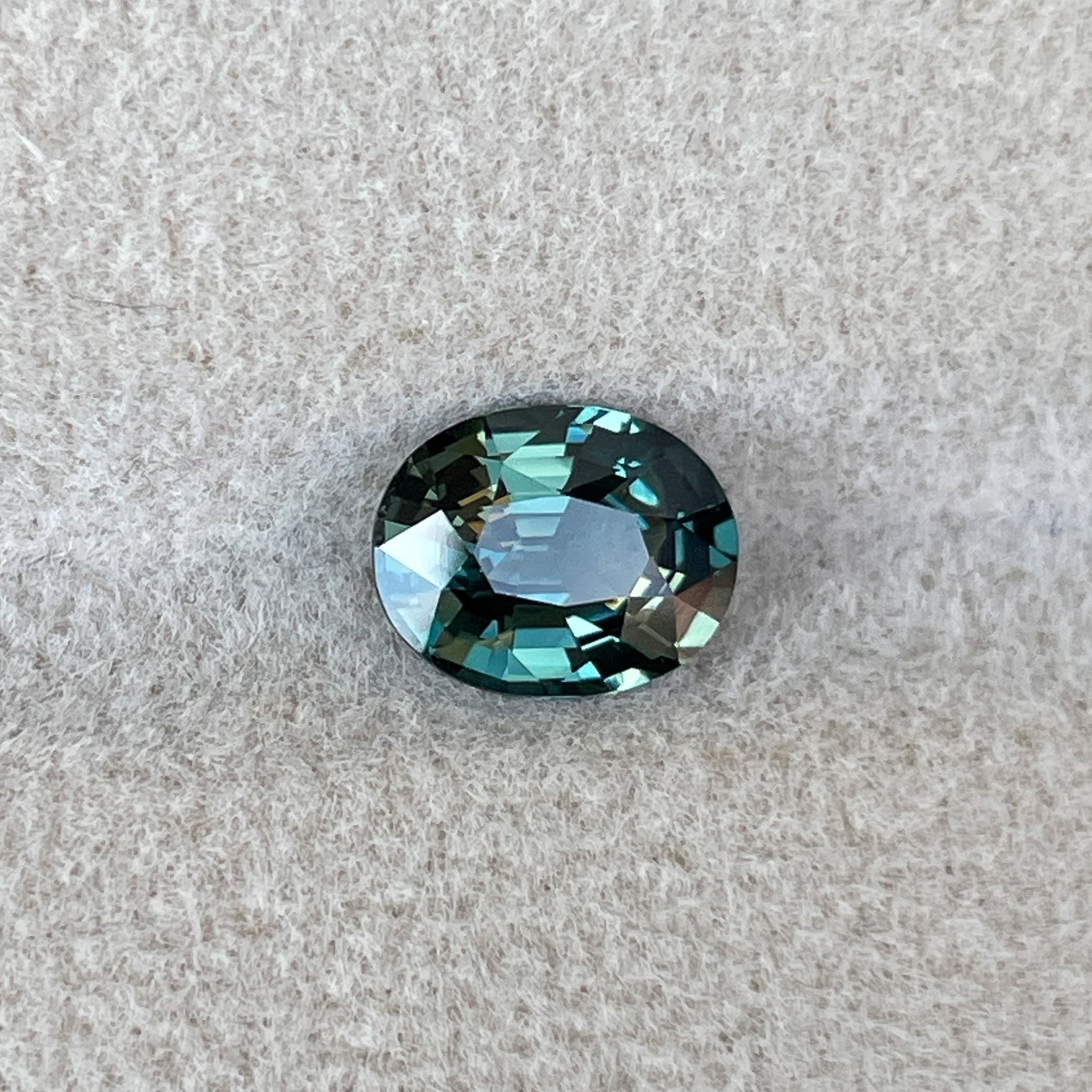 Natural teal green sapphire, 1.52 Ct oval cut, heat treated loose gemstone from NASHGEMS for jewelry or engagement rings.