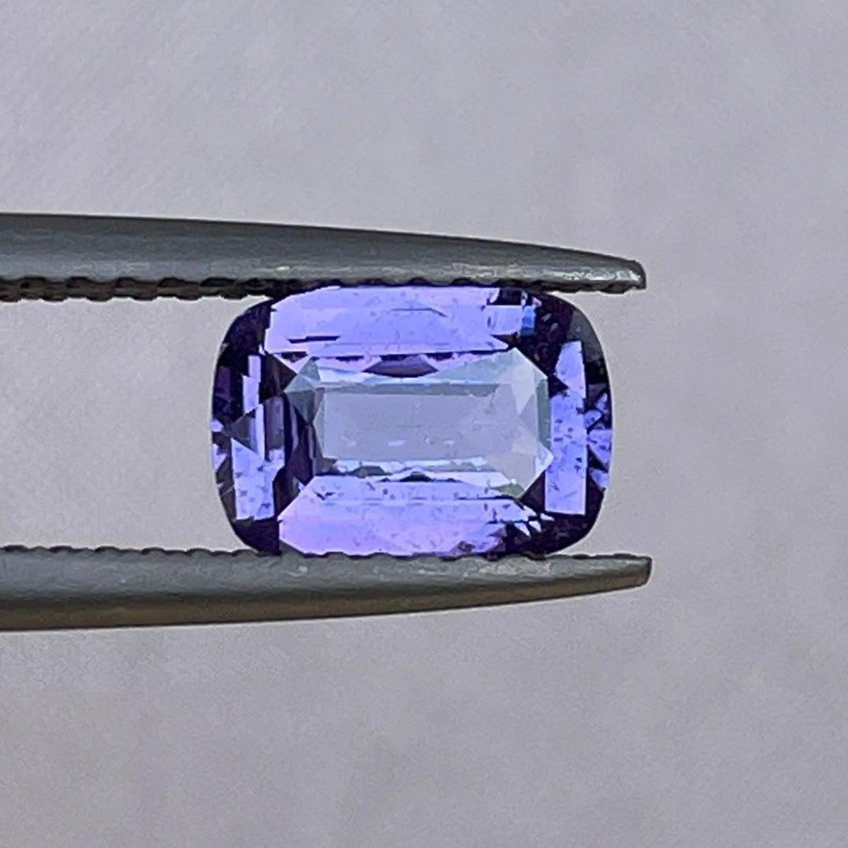 Loose purple sapphire gemstone, 1.27 carats, vibrant purple-pink color, ideal for October birthstone jewelry from NASHGEMS.