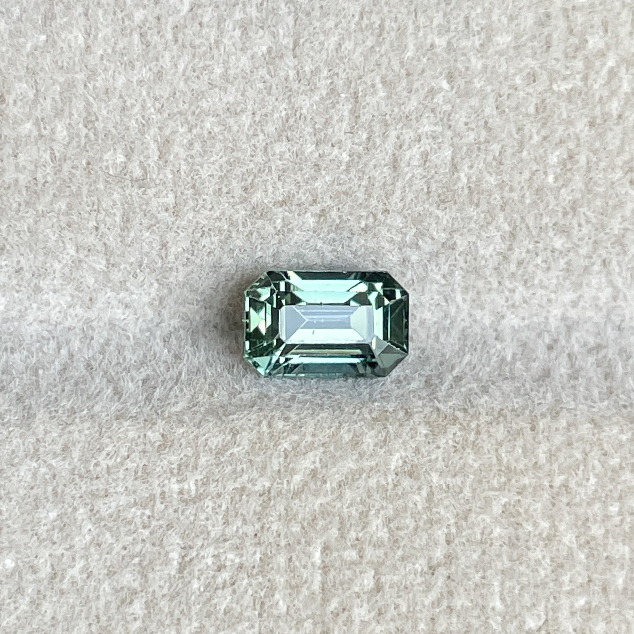 Natural pale green teal sapphire 1.24 Ct emerald cut by NASHGEMS, loose gemstone ideal for engagement or custom jewelry.