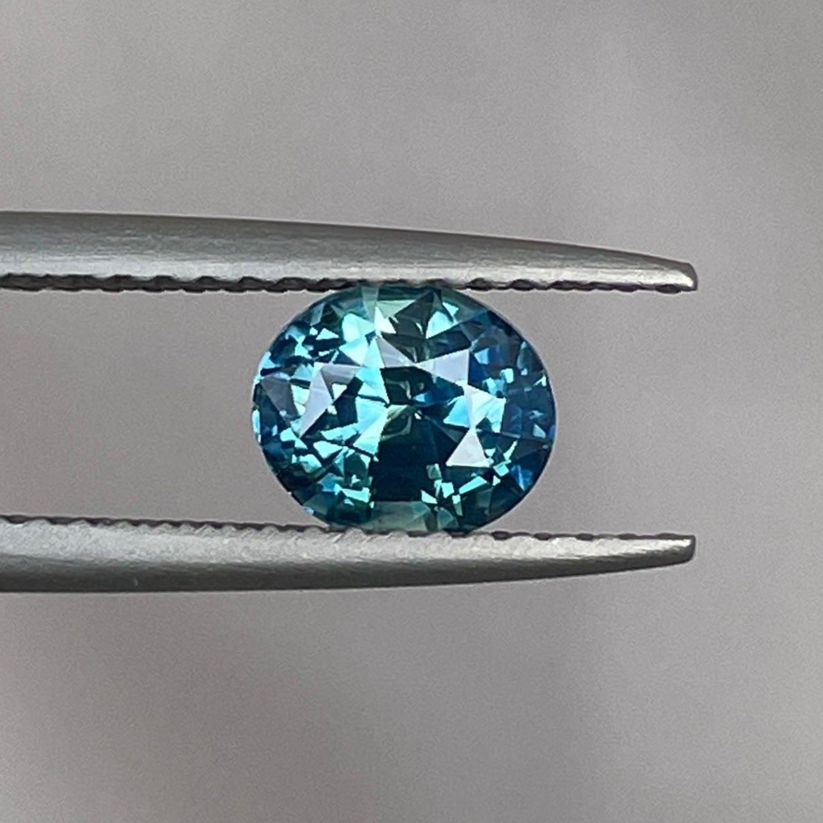 Natural blue-green sapphire oval pendant featuring 1.12 carats, showcasing a vibrant teal sapphire for custom jewelry by NASHGEMS.
