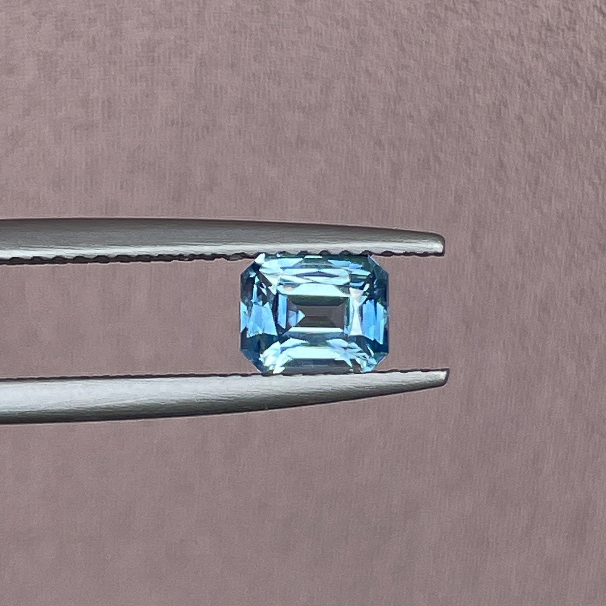 Natural pale blue teal sapphire, 1.08 ct emerald cut loose gemstone by NASHGEMS, ideal for engagement rings or custom jewelry.