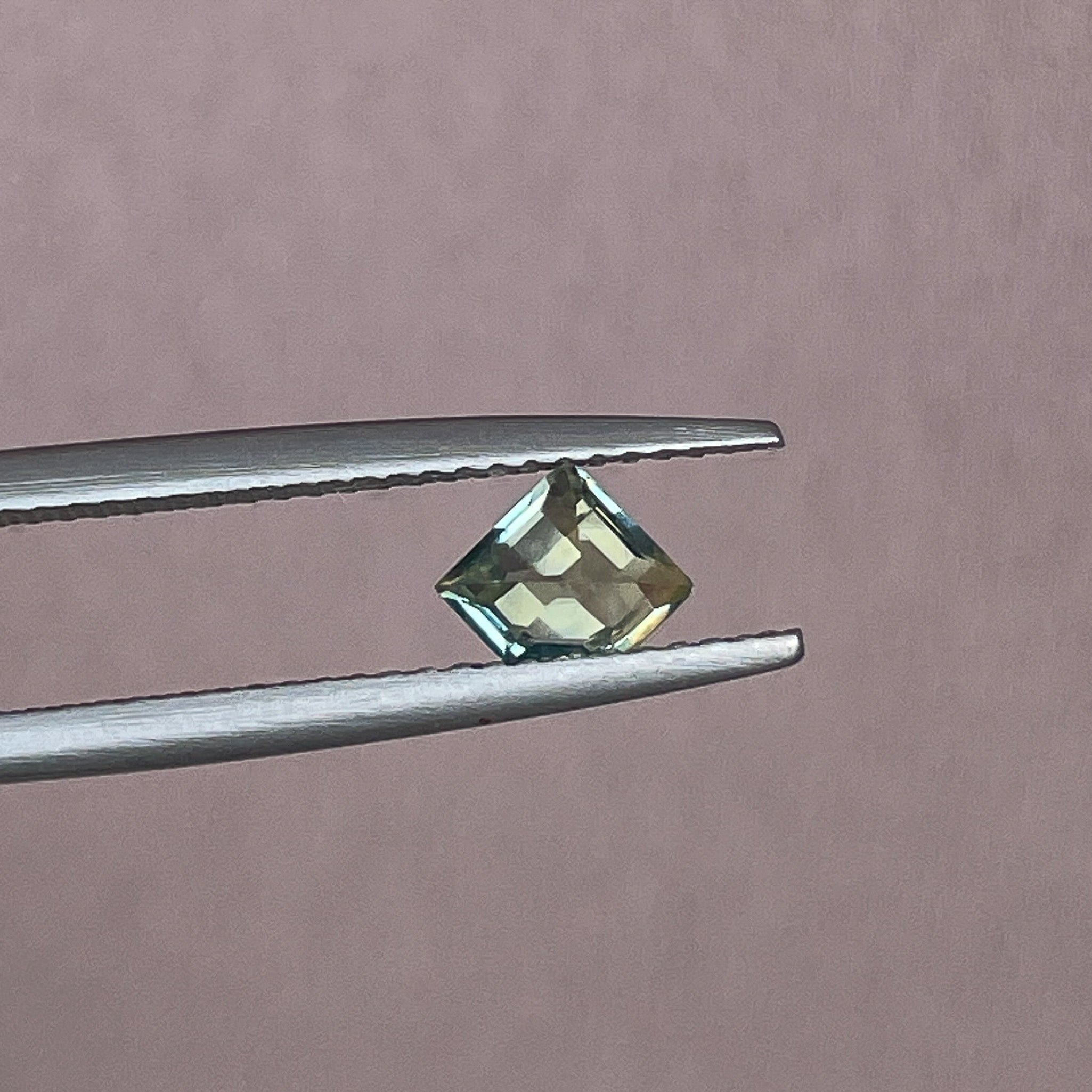 Natural pale green yellow sapphire, 0.72 ct shield cut loose teal sapphire from NASHGEMS for engagement or custom jewelry.