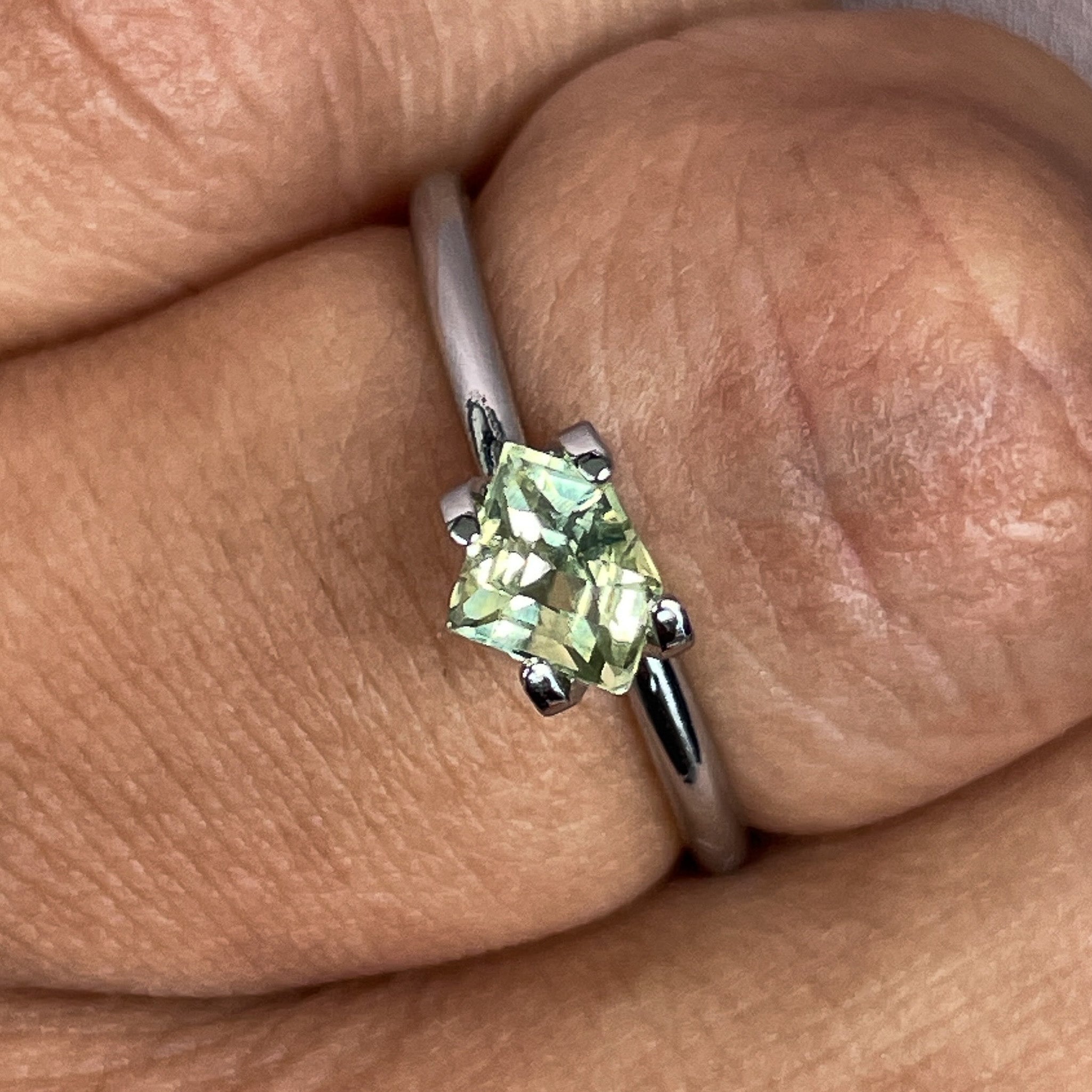 Natural pale green-yellow teal sapphire, 0.72 Ct shield cut loose gemstone by NASHGEMS, ideal for engagement or custom jewelry.