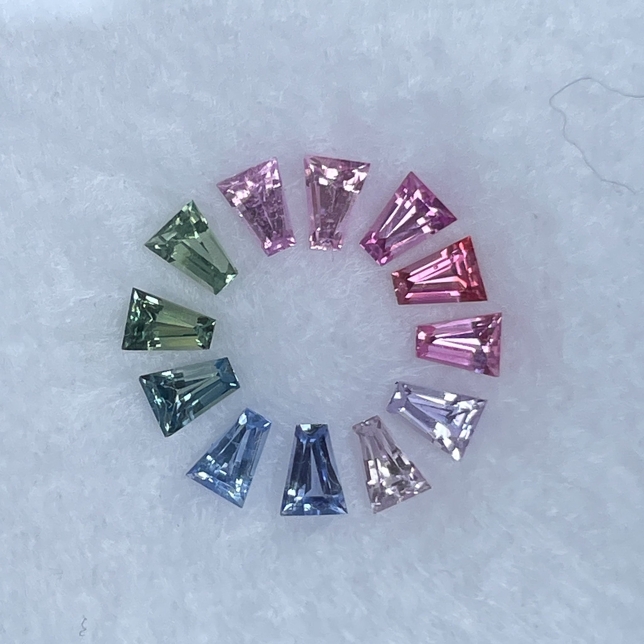 Natural rainbow sapphire lot featuring 1.37 carats of multi-colored loose sapphires for custom jewelry crafting.