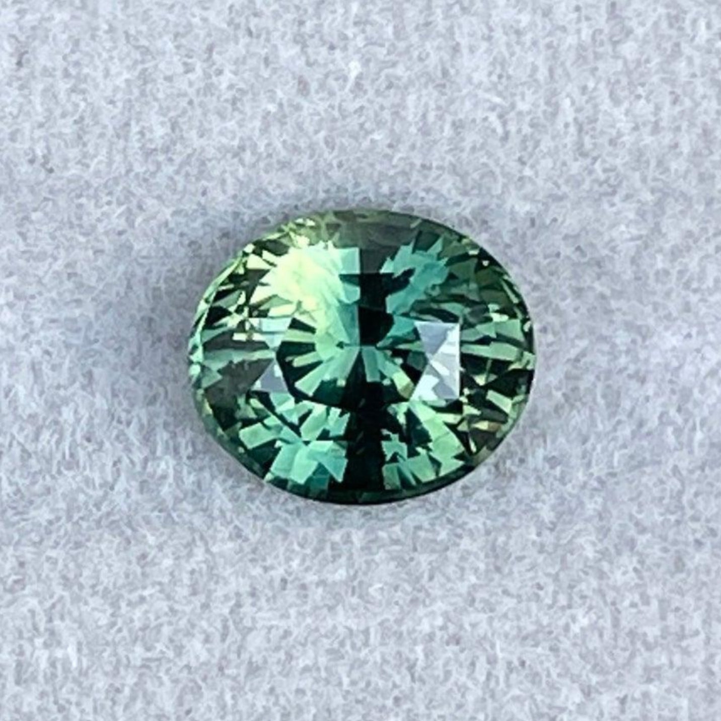 Teal blue and green parti sapphire oval cut loose gemstone, 2.09 carats, from NASHGEMS, ideal for engagement and wedding jewelry.
