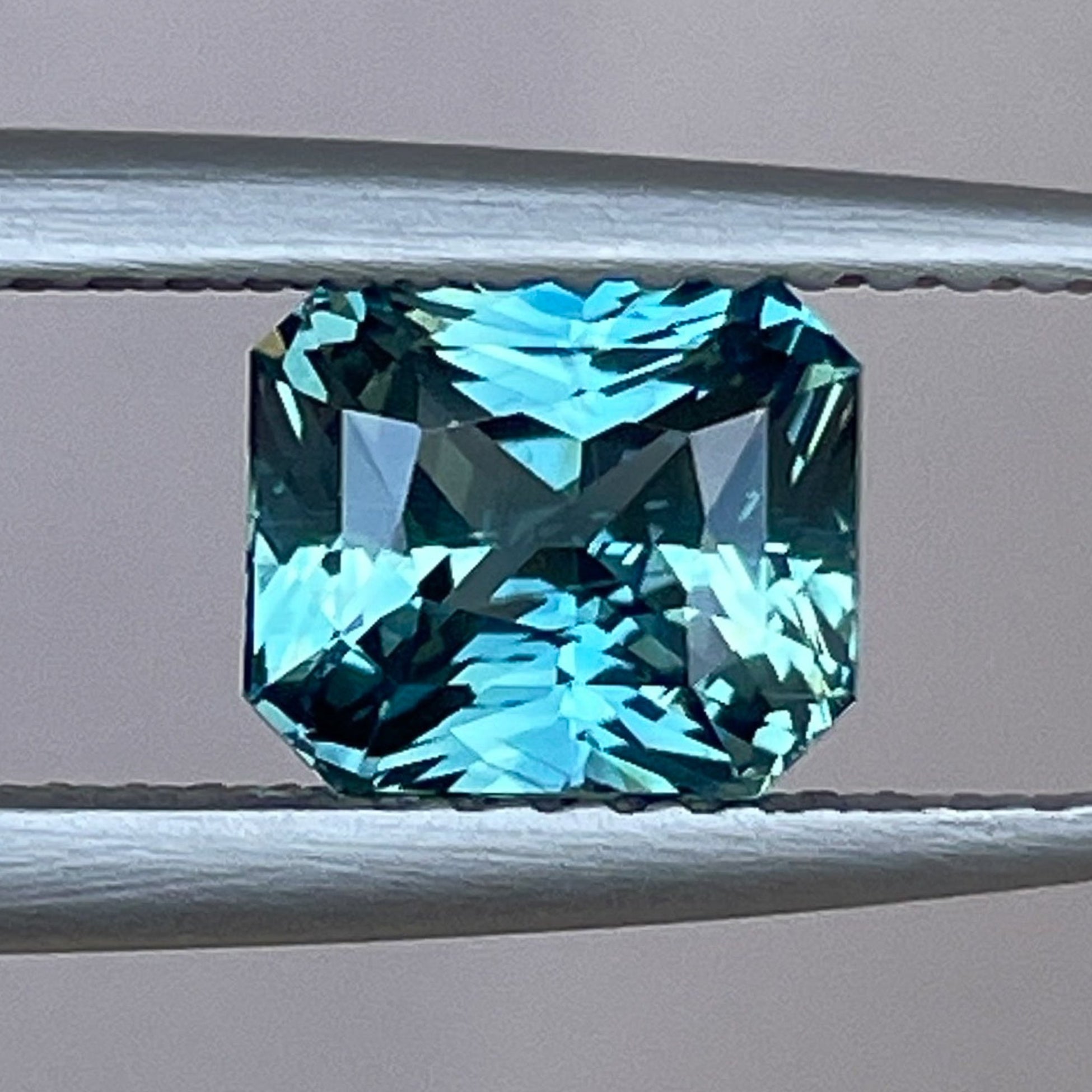 Teal sapphire loose gemstone with radiant cut, 1.73 carats, from NASHGEMS, ideal for engagement rings or custom jewelry.