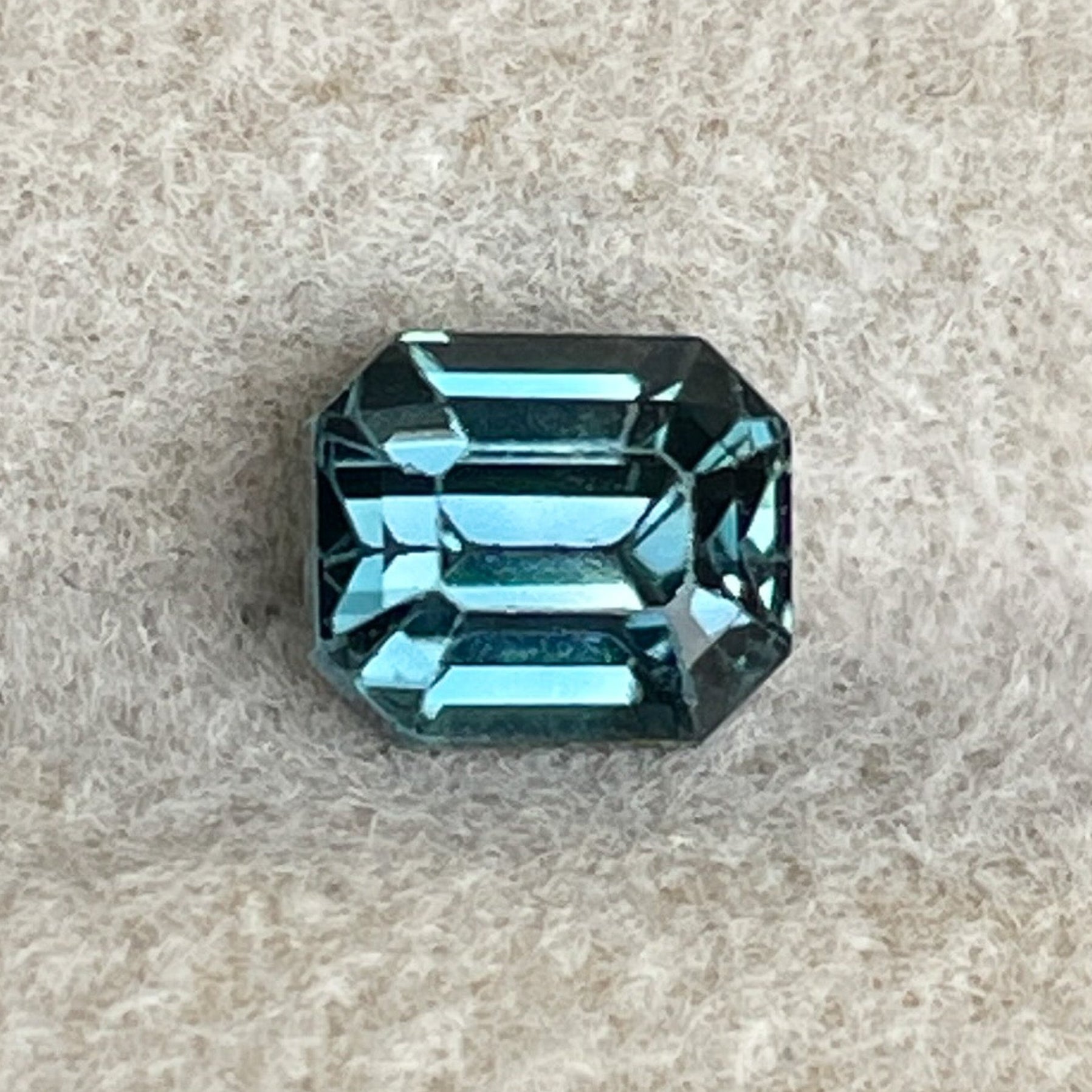 Natural teal blue sapphire 1.00 Ct emerald cut loose stone from NASHGEMS, ideal for engagement rings or custom jewelry.