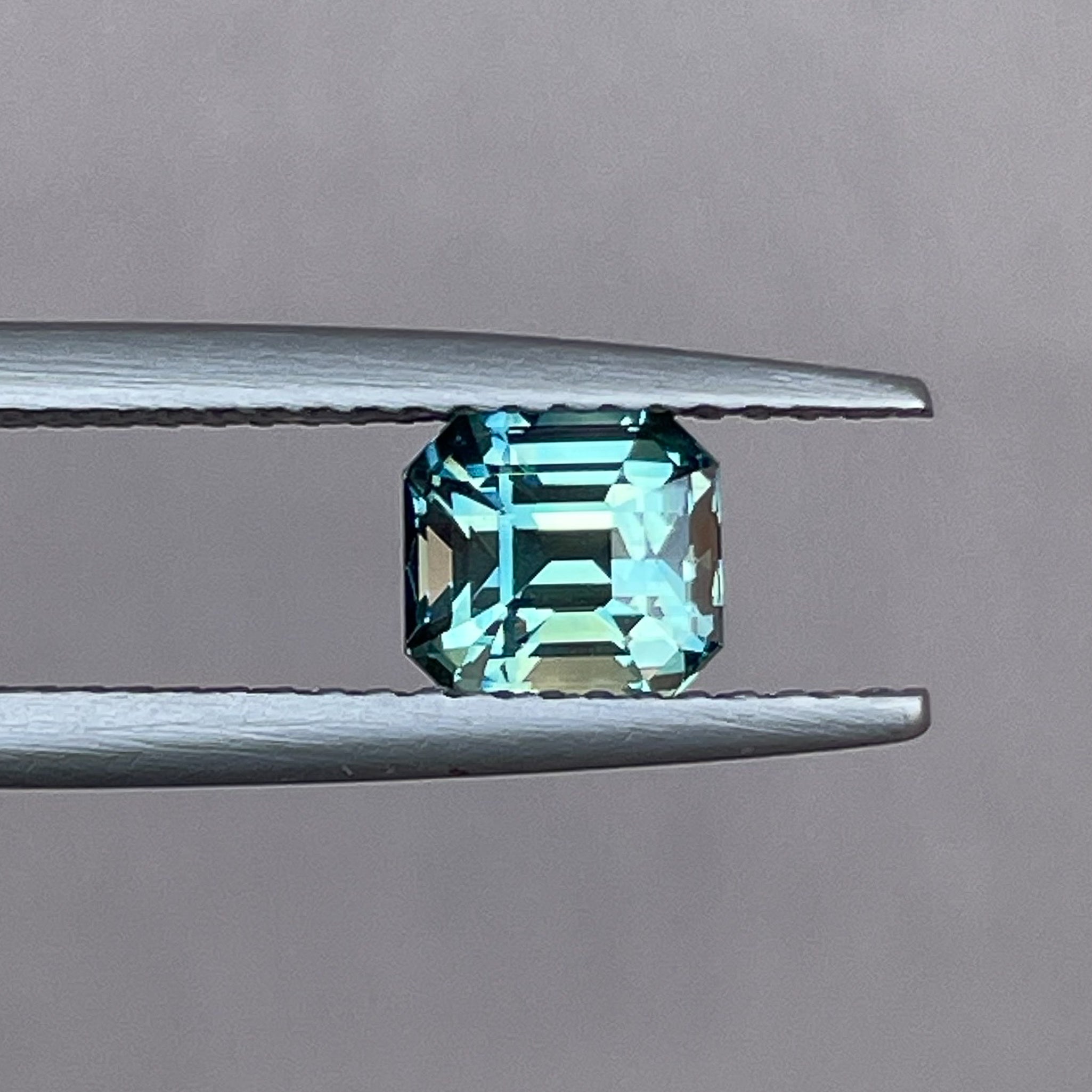 Natural teal green sapphire, 1.36 Ct emerald cut, loose gemstone by NASHGEMS, ideal for engagement or custom jewelry.