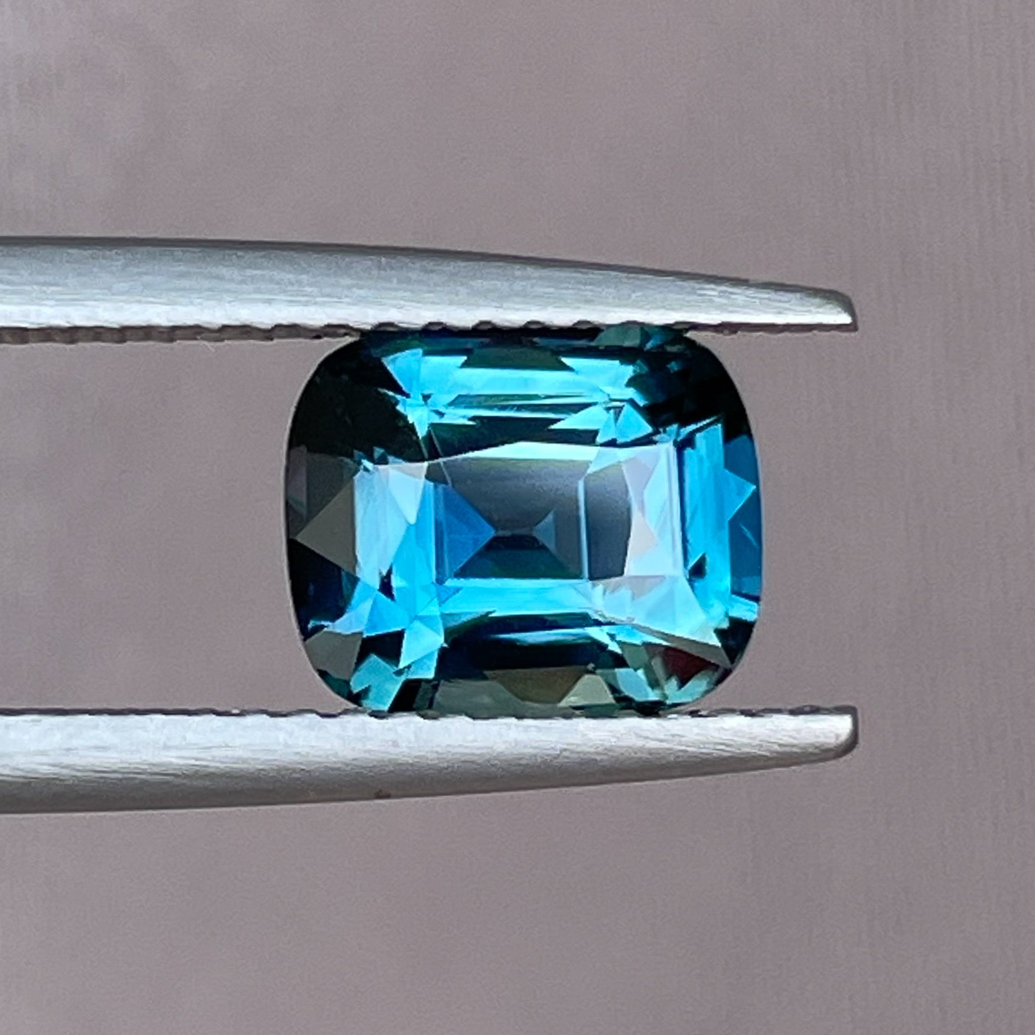 Teal blue sapphire loose gemstone, 2.52 carats, cushion cut, heat treated, ideal for engagement rings or custom jewelry.
