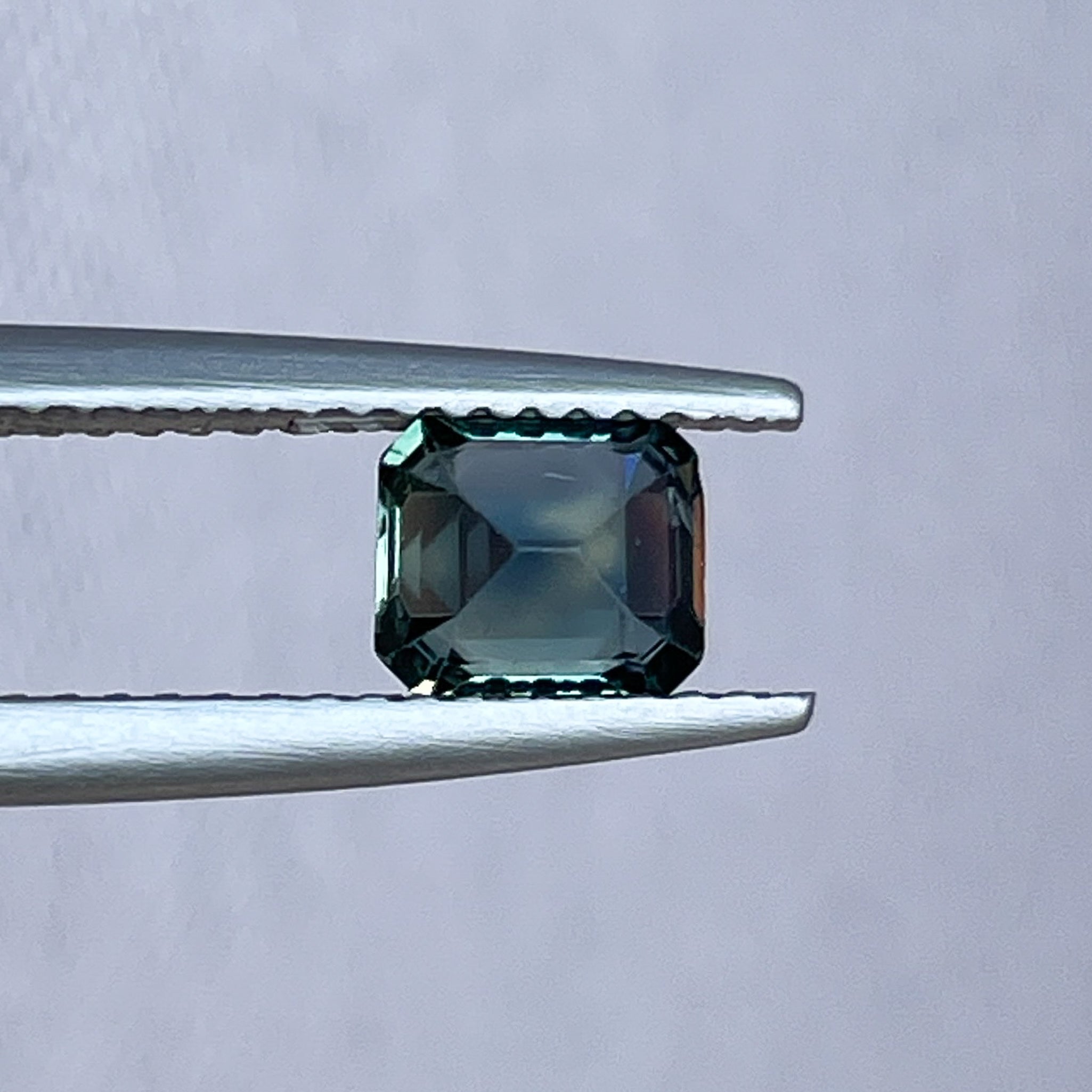 Natural teal blue sapphire loose stone, 1.06 Ct emerald cut, from NASHGEMS, ideal for engagement rings or custom jewelry.