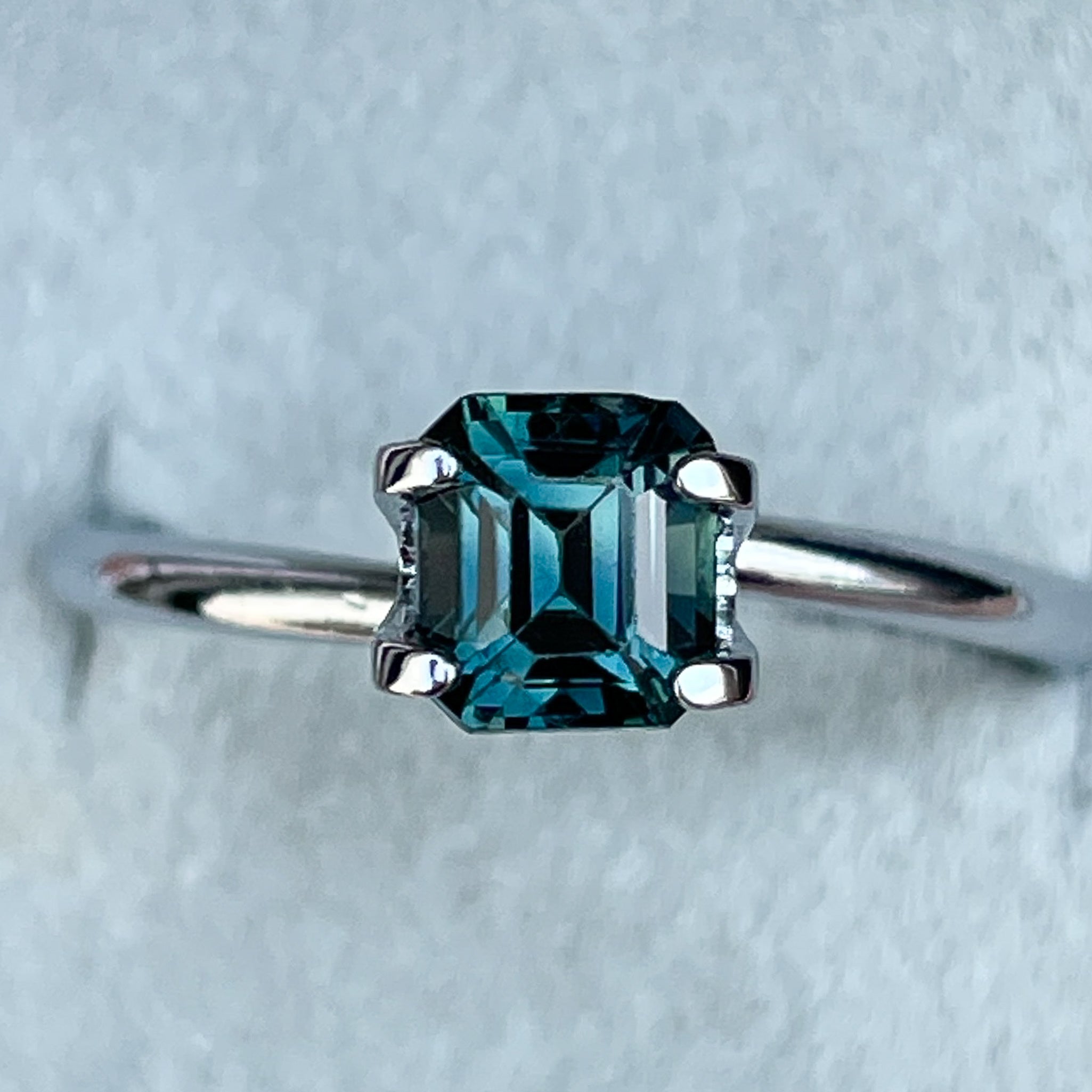 Natural teal blue sapphire 1.06 ct emerald cut loose gemstone from NASHGEMS, ideal for engagement rings or custom jewelry.