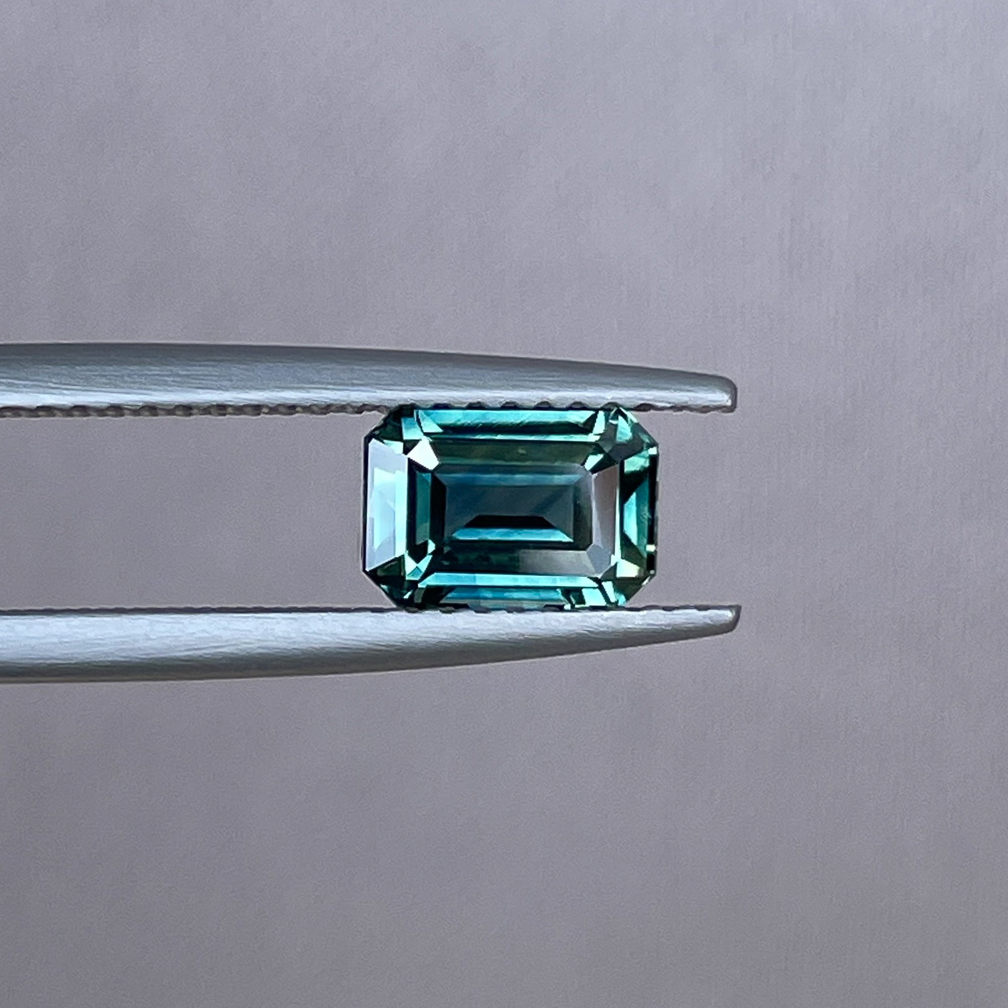 Natural teal sapphire loose gemstone, 1.52 Ct emerald cut by NASHGEMS, ideal for engagement rings or custom jewelry.