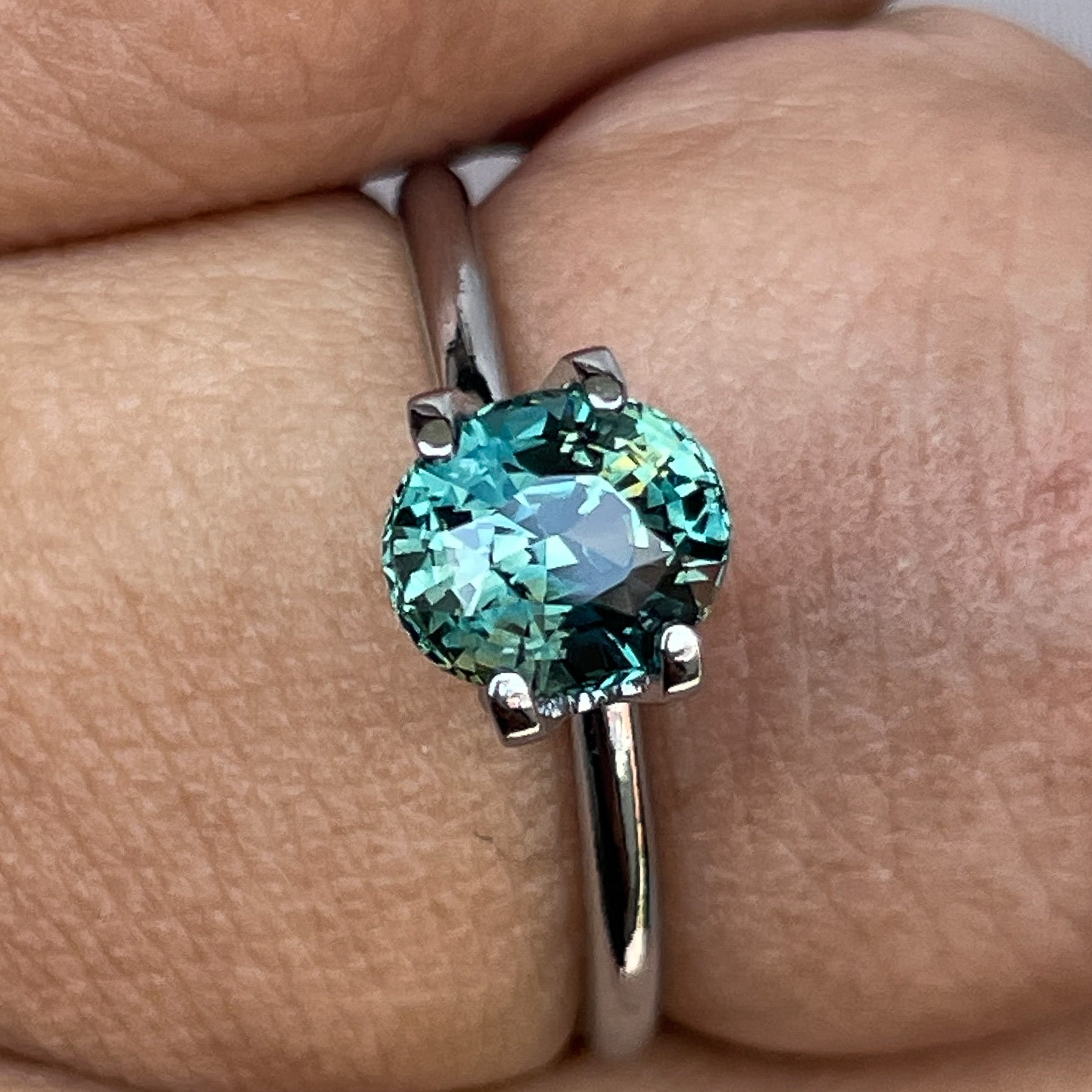 Natural teal sapphire loose stone, 1.56 Ct oval cut by NASHGEMS, showcasing vibrant blue-green gemstone for jewelry making.