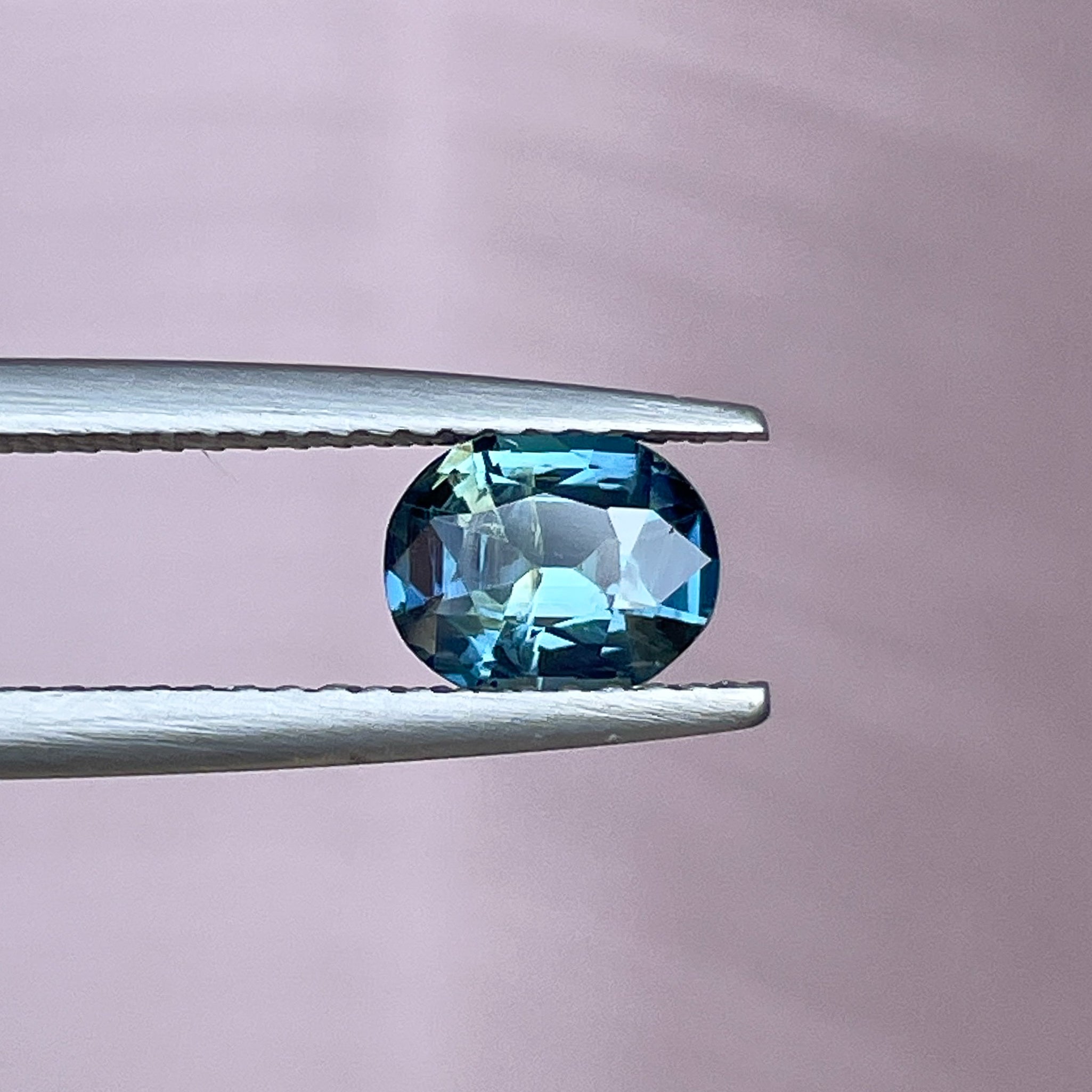 Natural teal sapphire loose gemstone, 1.03 Ct oval cut in blue-green hues, ideal for engagement rings or custom jewelry by NASHGEMS.