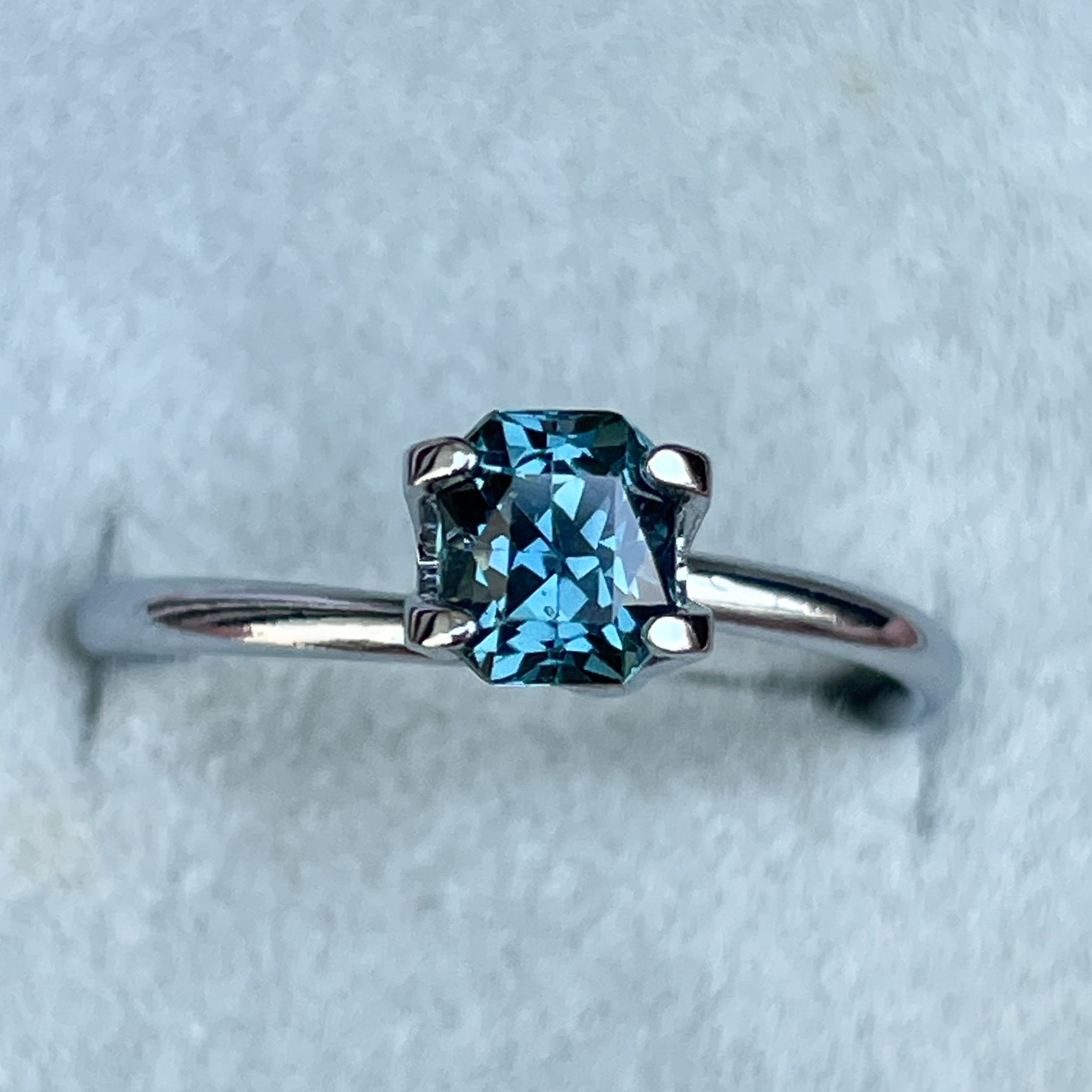 Teal blue sapphire loose gemstone 0.98 Ct radiant cut by NASHGEMS, ideal for engagement rings or custom jewelry designs.