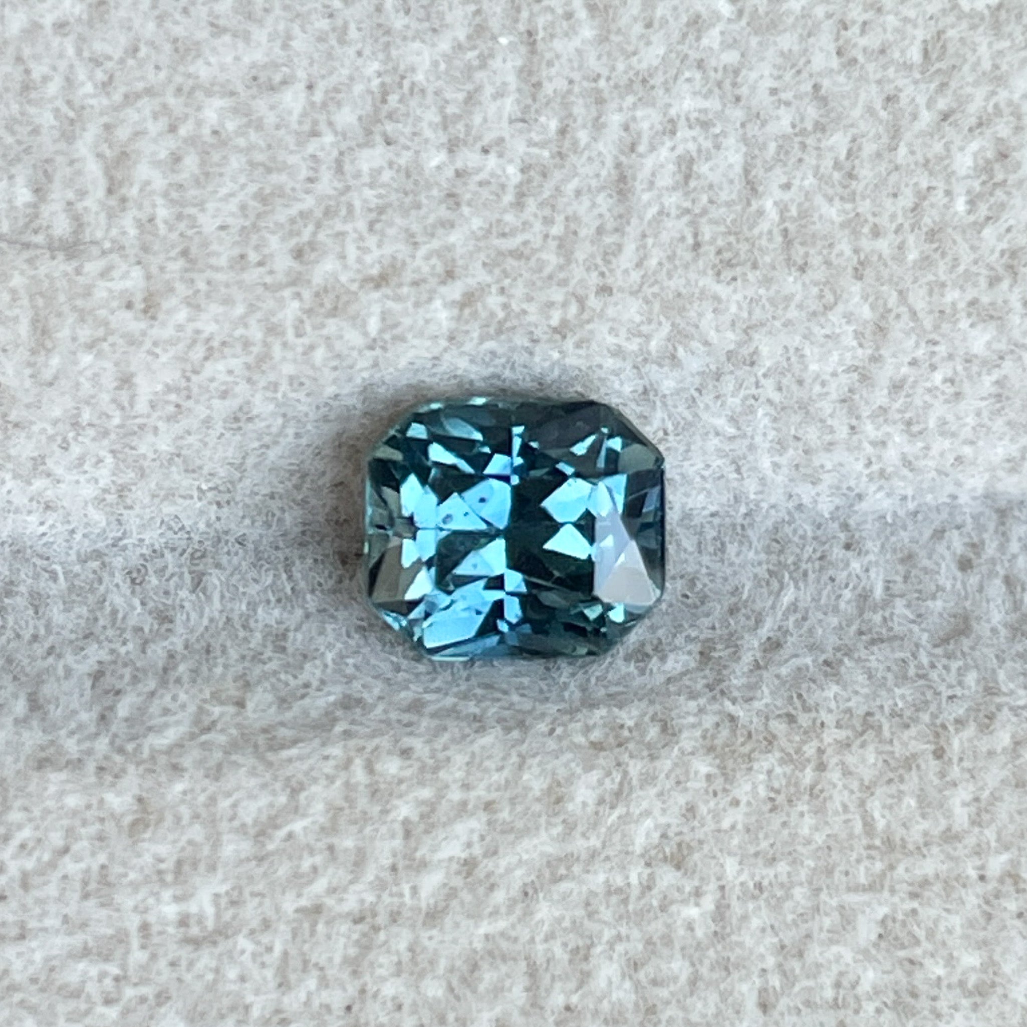 Natural teal blue sapphire from NASHGEMS, 0.98 Ct radiant cut loose gemstone for engagement rings or custom jewelry.