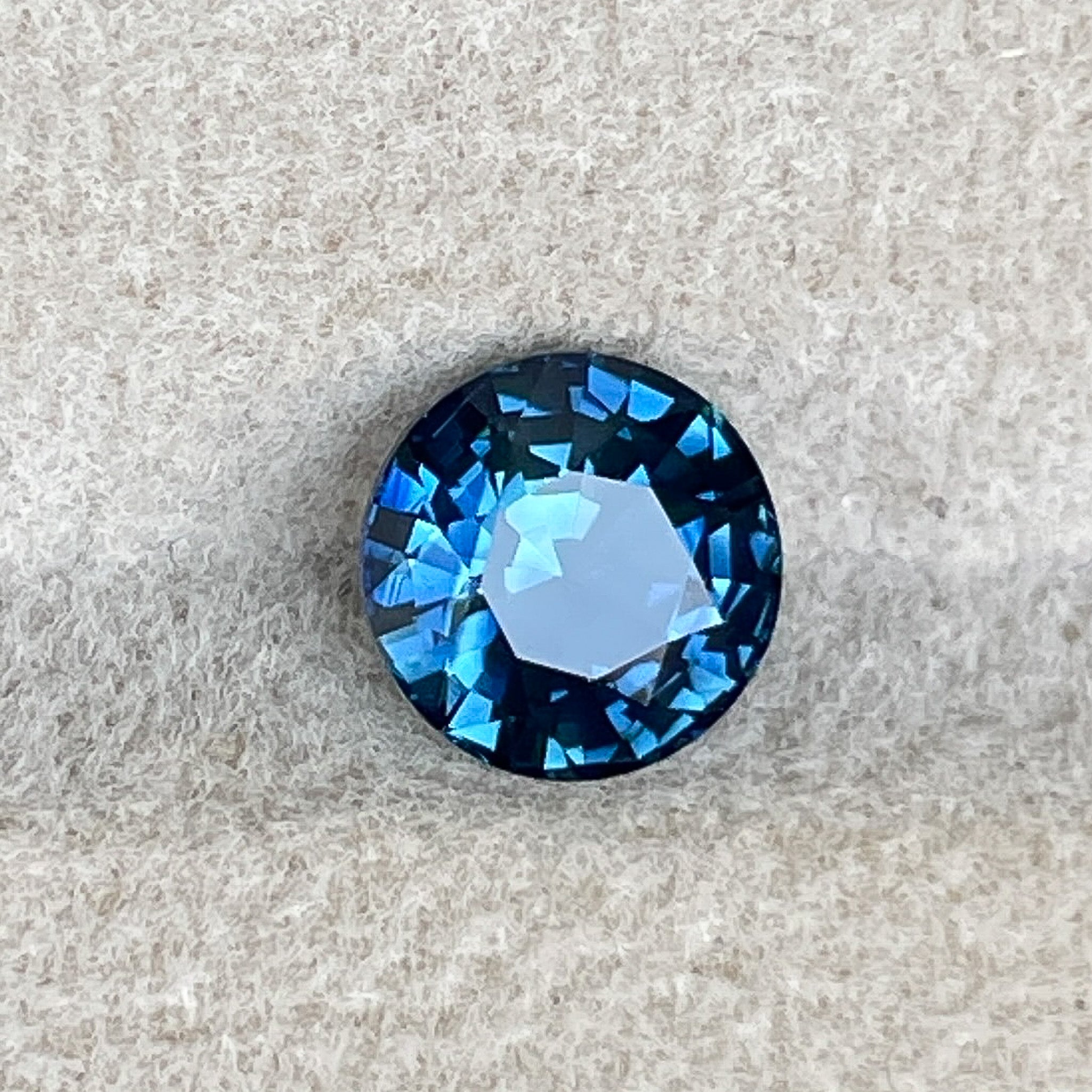 Natural teal blue sapphire 1.65 Ct round cut loose gemstone by NASHGEMS, ideal for engagement rings or custom jewelry designs.