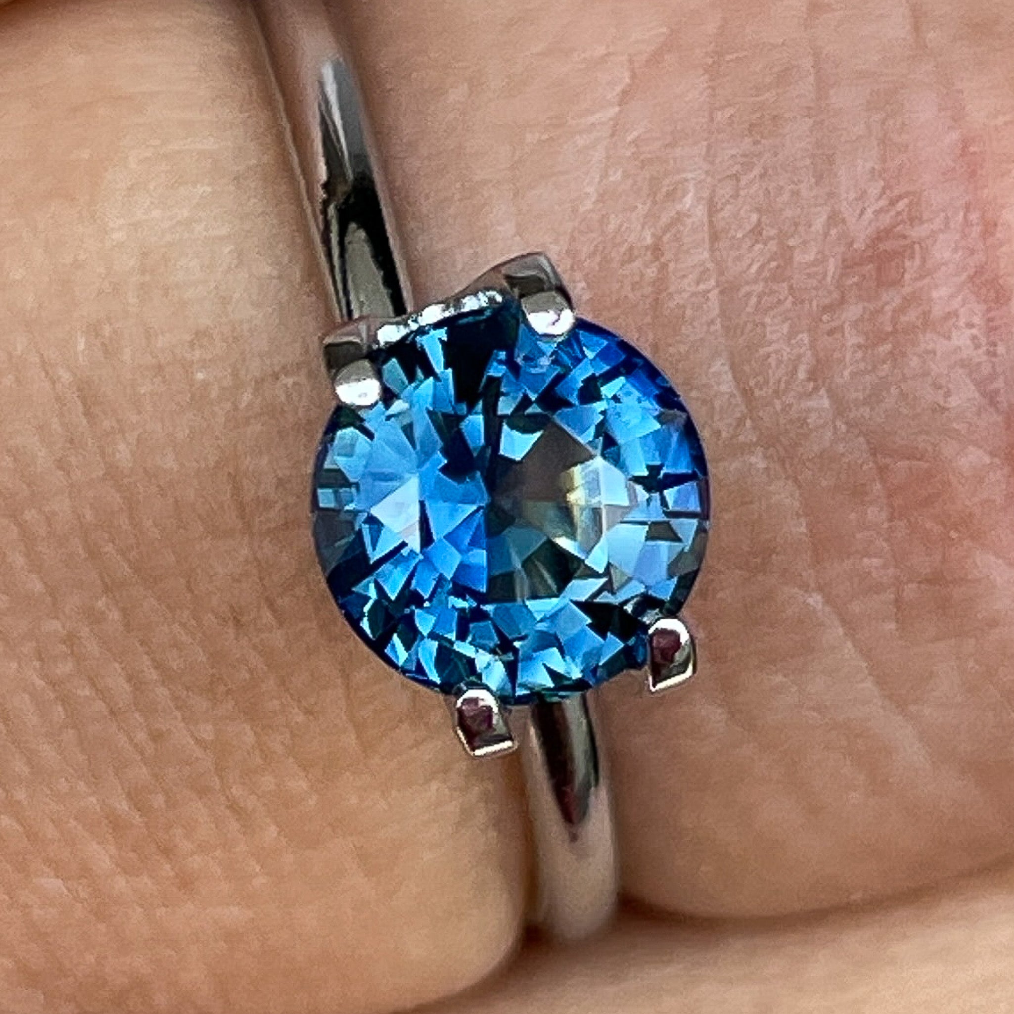 Natural teal blue sapphire 1.65 Ct round cut loose gemstone by NASHGEMS, ideal for engagement rings or custom jewelry.