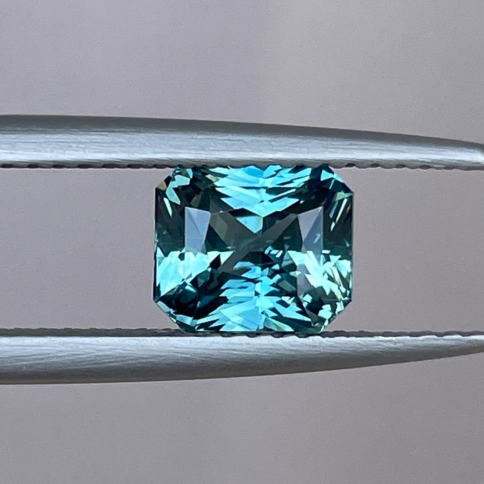 Natural teal sapphire by NASHGEMS, 1.73 Ct radiant cut loose sapphire for engagement rings or custom jewelry designs.