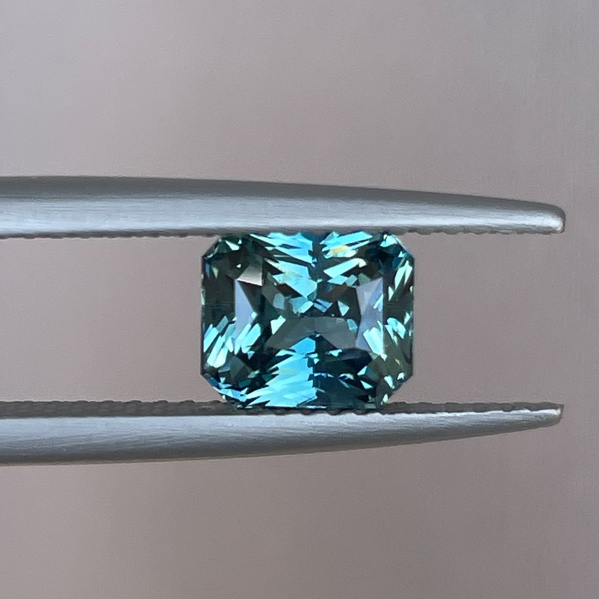 Natural teal sapphire by NASHGEMS, radiant cut 1.73 Ct loose sapphire gemstone for engagement or custom jewelry.