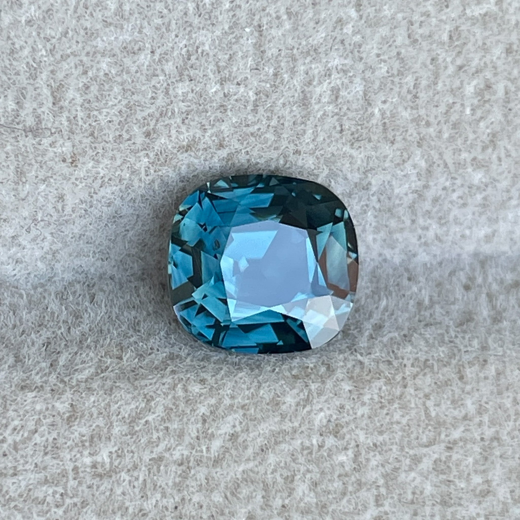 Natural teal sapphire 2.02 Ct cushion cut, loose gemstone by NASHGEMS, ideal for engagement rings or custom jewelry.