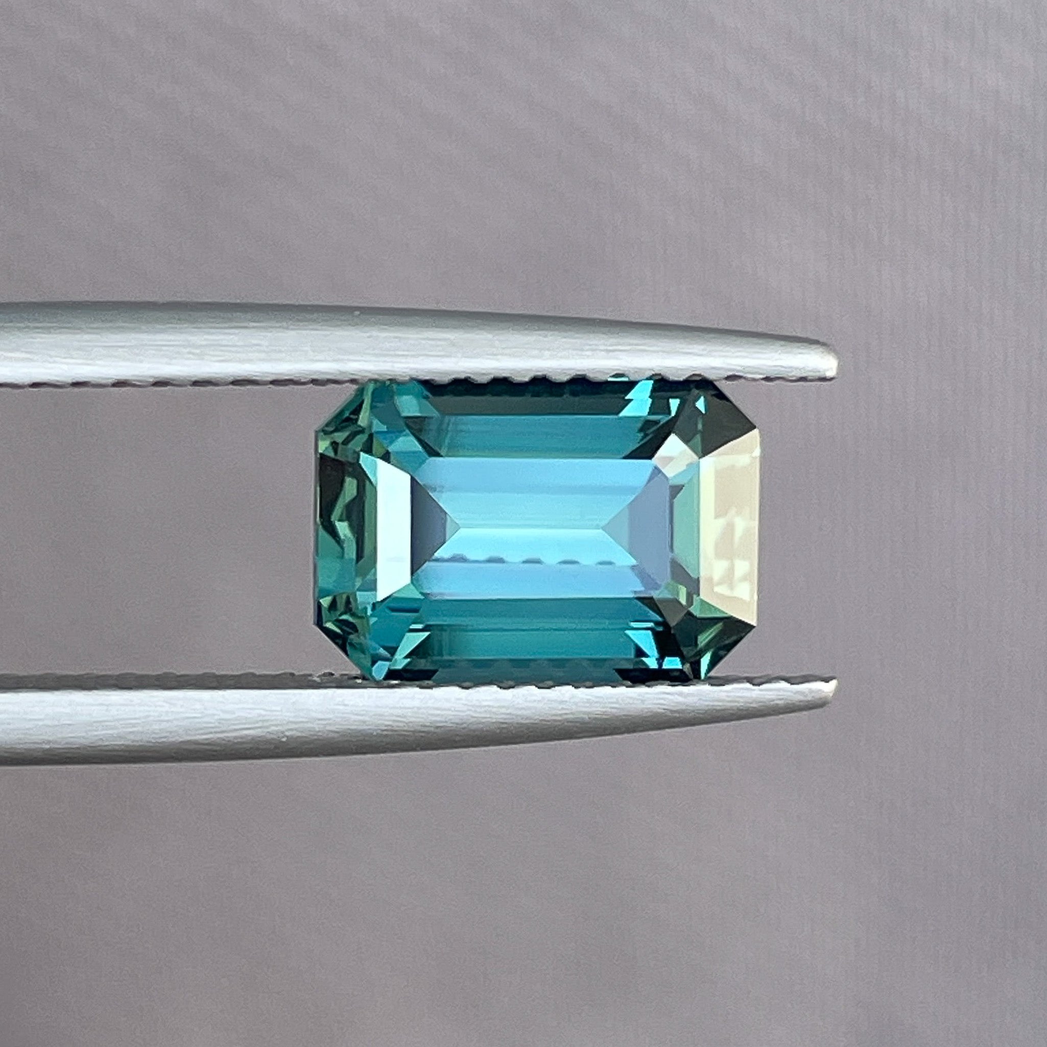 Natural teal blue-green sapphire, 3.71 carats, emerald cut, loose gemstone from NASHGEMS for jewelry or engagement rings.