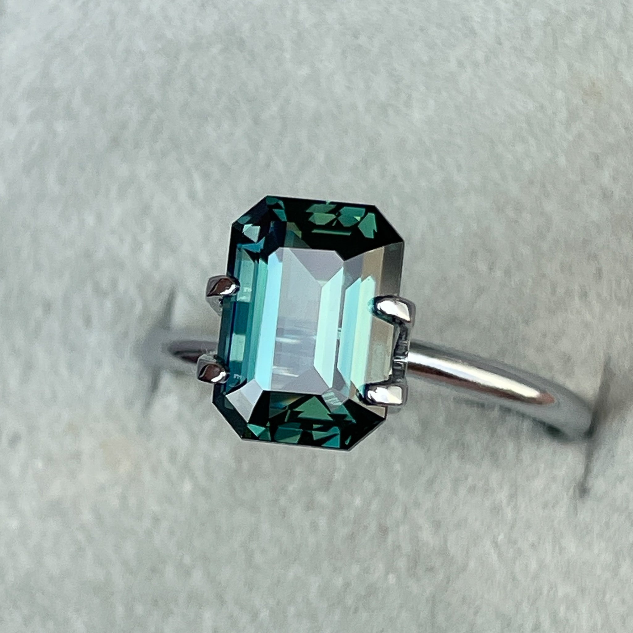 Natural teal blue-green sapphire, 3.71 Ct emerald cut loose gemstone by NASHGEMS, ideal for rings or custom jewelry.