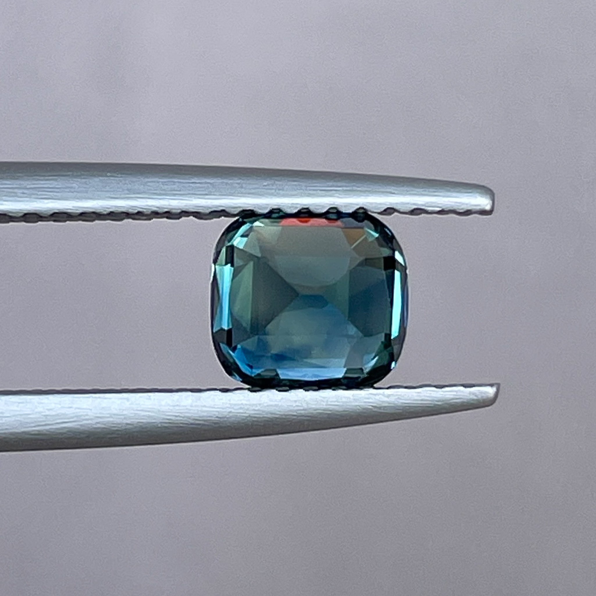 Natural teal blue sapphire 1.52 Ct cushion cut loose gemstone from NASHGEMS, ideal for engagement rings or custom jewelry.