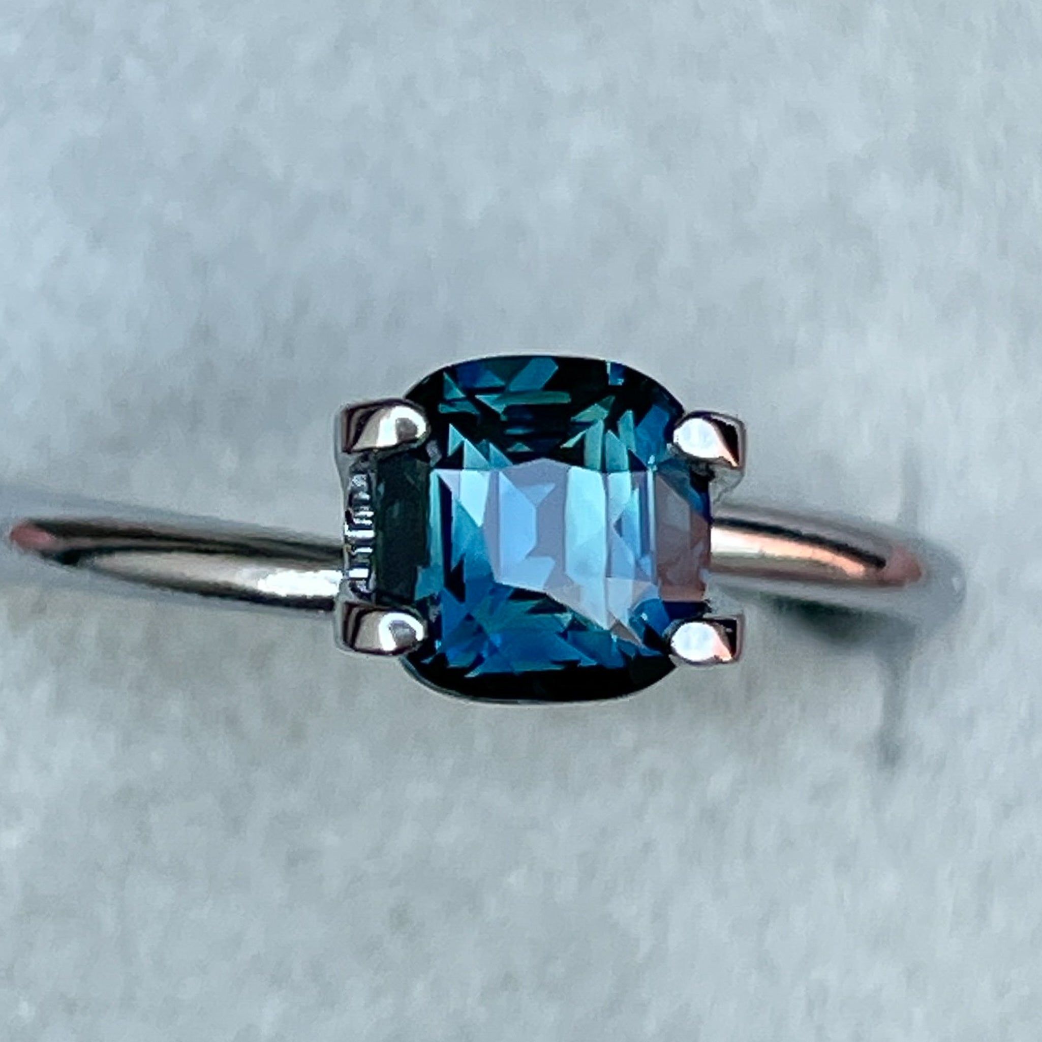 Natural teal blue sapphire, 1.52 ct cushion cut loose gemstone from NASHGEMS, ideal for engagement rings or custom jewelry.