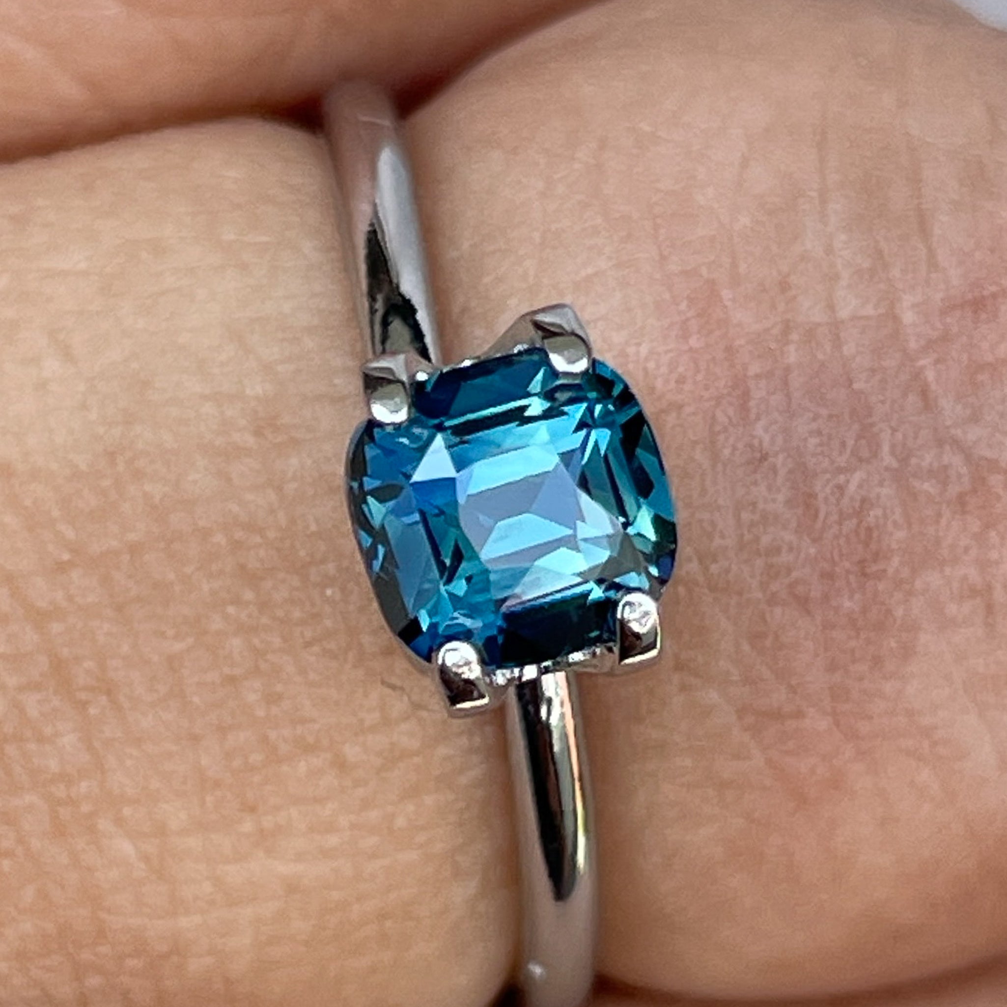 Natural teal blue sapphire 1.52 ct cushion cut loose gemstone by NASHGEMS, suitable for engagement rings or custom jewelry.