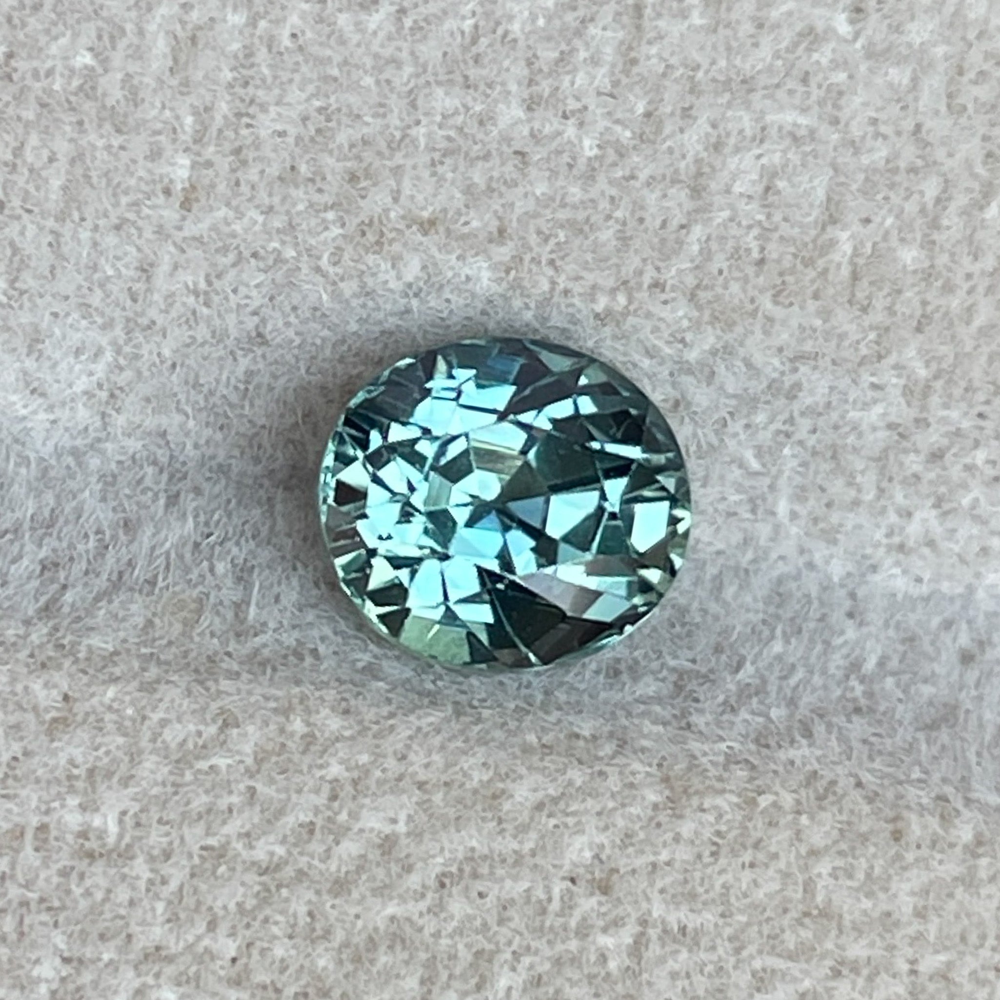 Natural teal sapphire loose stone, 1.65 Ct oval cut by NASHGEMS, ideal for engagement rings or custom jewelry.