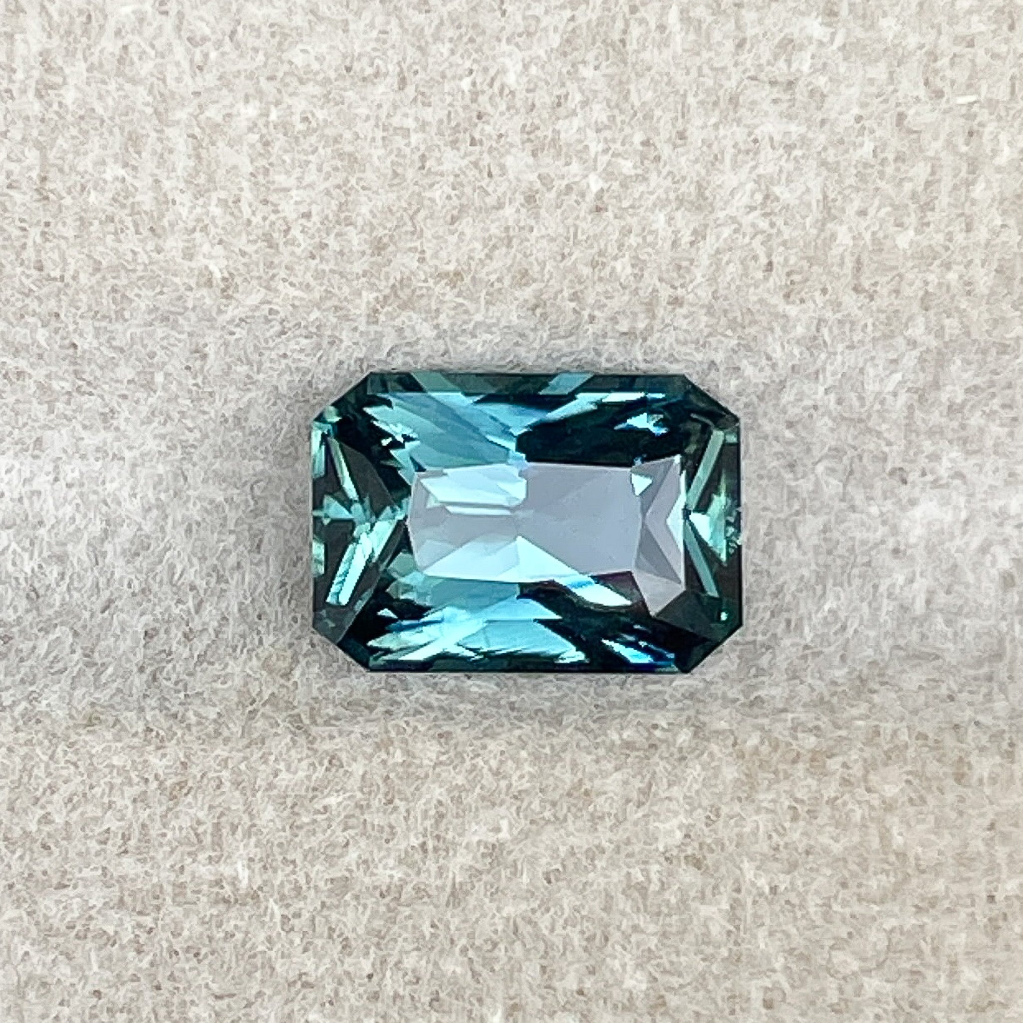 Natural teal blue-green sapphire, 1.71 carats, radiant cut, loose no heat gemstone by NASHGEMS for jewelry or engagement rings.