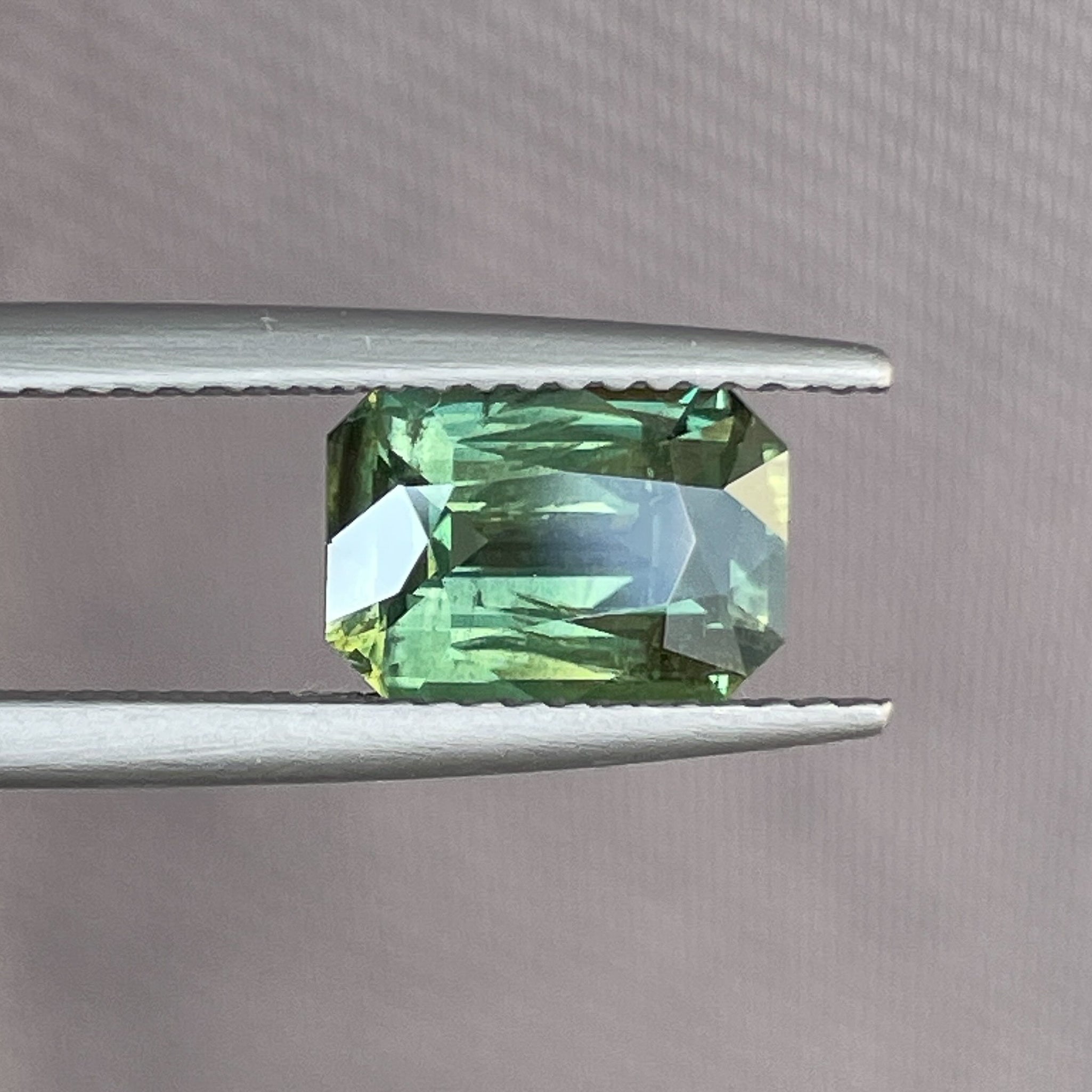 Natural green sapphire 2.36 Ct radiant emerald cut from NASHGEMS, showcasing a vibrant teal color and heat-treated clarity.